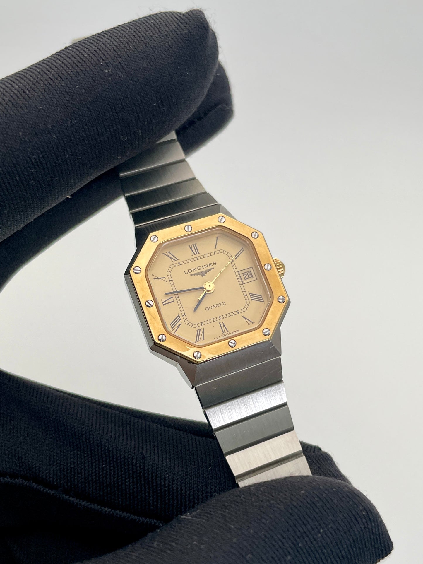 Close-up view of the 1980s Longines Octagon "Royal Oak" ladies quartz watch, focusing on the gold-tone dial, octagonal bezel, and bezel screws.