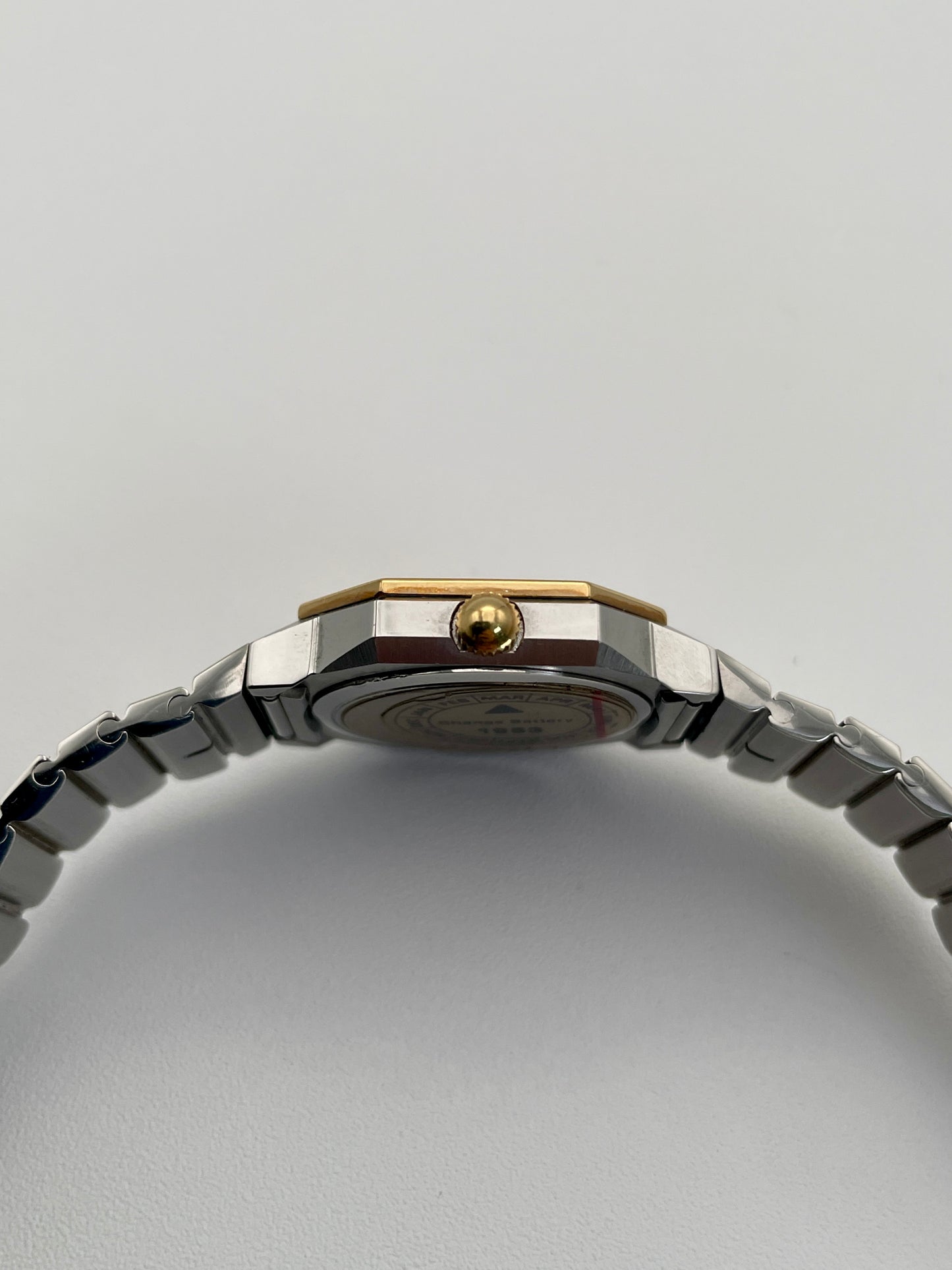 Close-up of the crown and case side of the 1980s Longines Octagon "Royal Oak" ladies quartz watch, emphasizing the bezel screws.