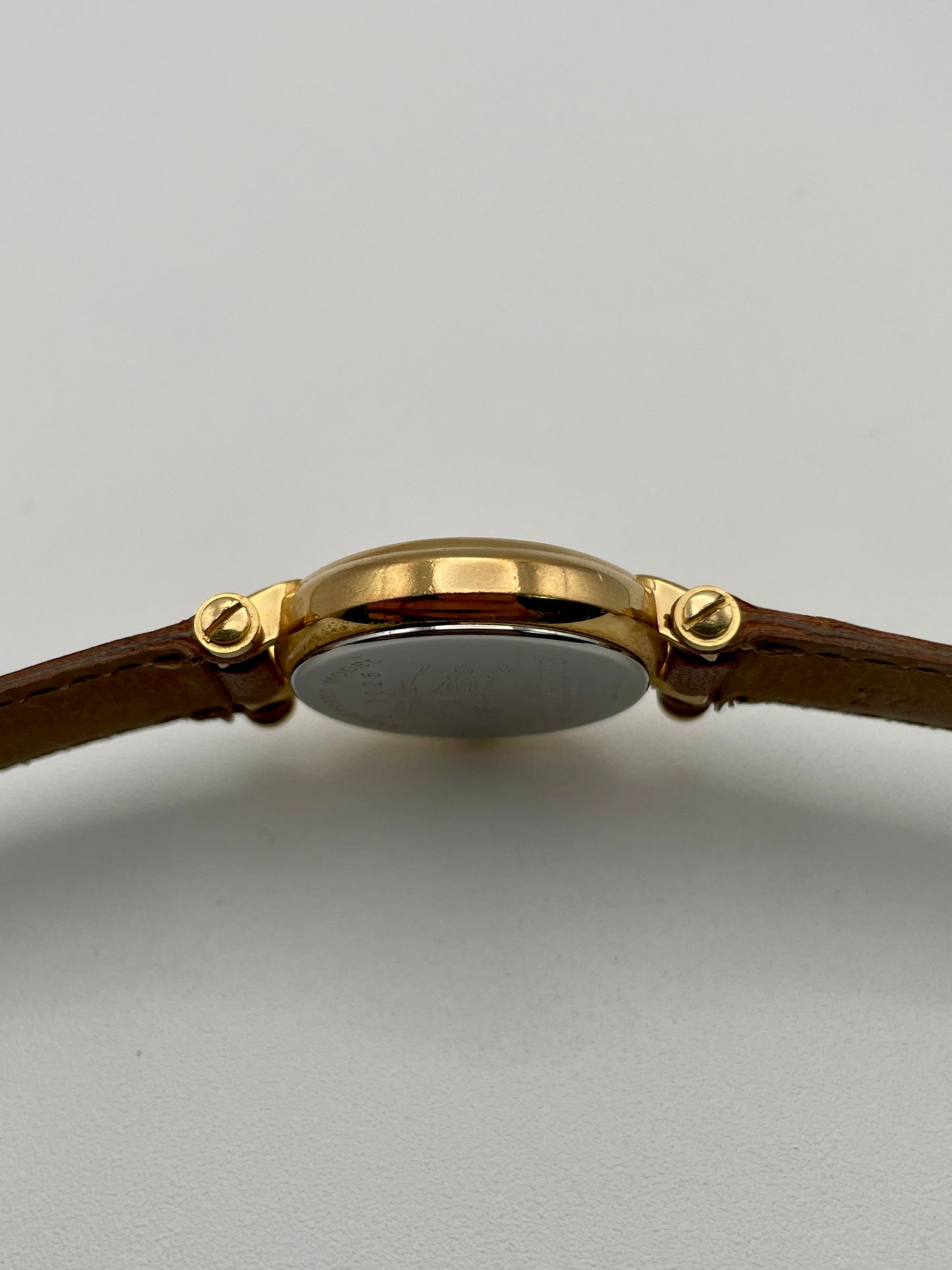 Side profile showing the polished gold-tone case of Burberry 3200 watch