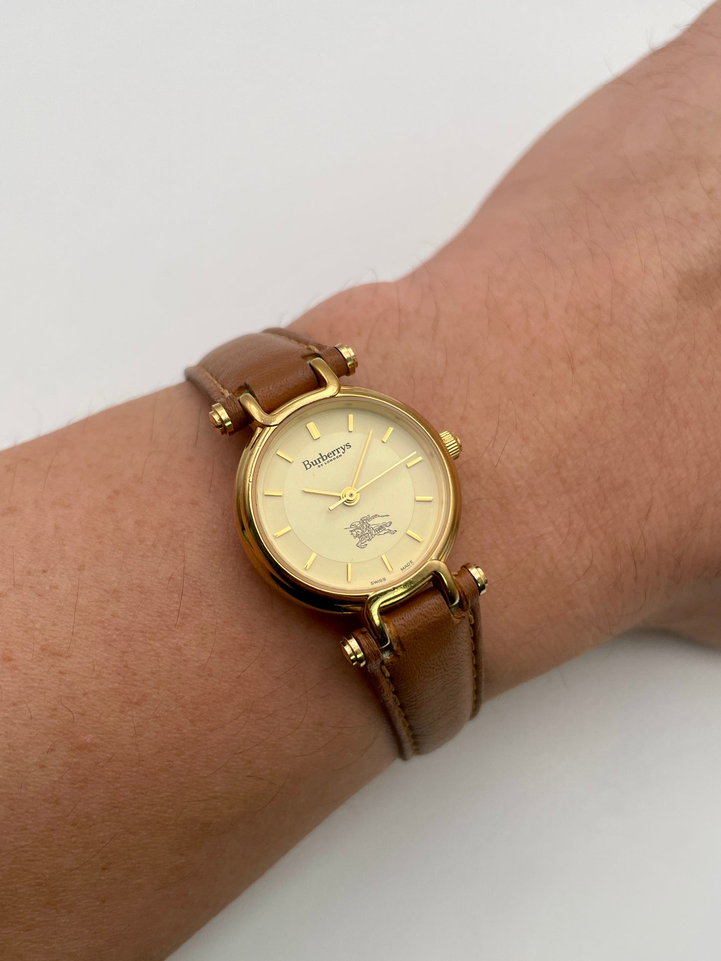 Wrist shot of Burberry 3200 vintage women’s watch in gold and tan strap