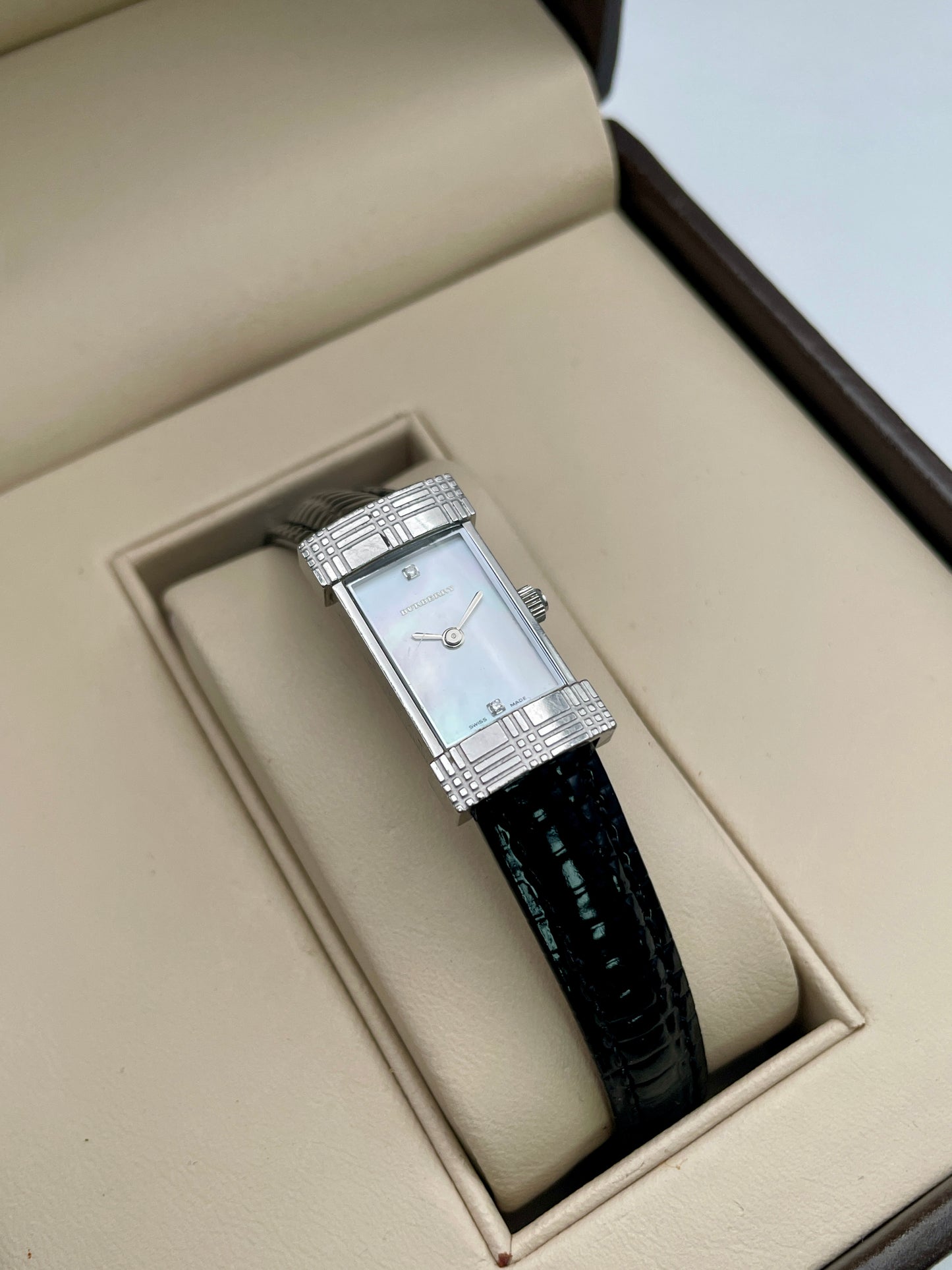 Burberry vintage women's watch with mother-of-pearl dial in a steel case and black leather strap, shown in original box