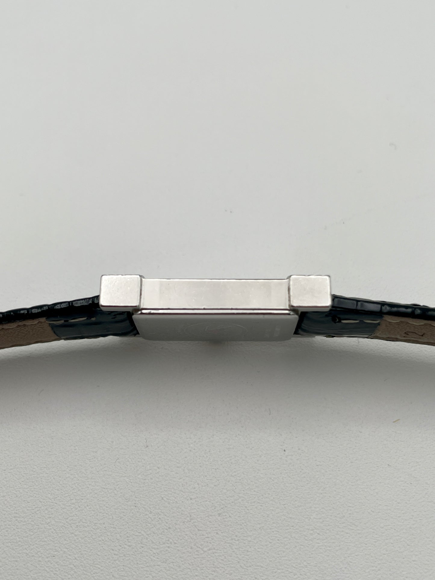 Profile view of the rectangular stainless steel case of the Burberry vintage watch
