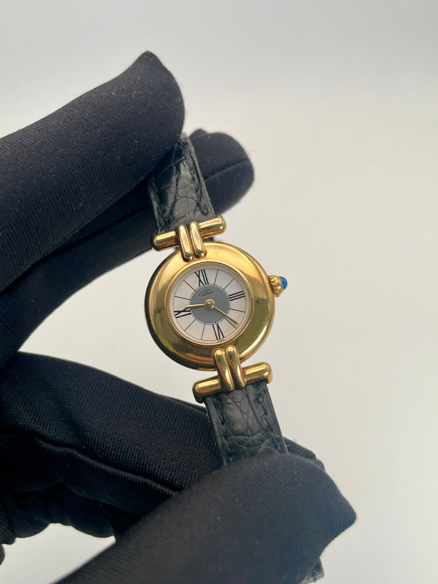 Close-up view of Cartier Colisée Vermeil watch showing detailed craftsmanship of the gold-tone case and Roman numeral dial.
