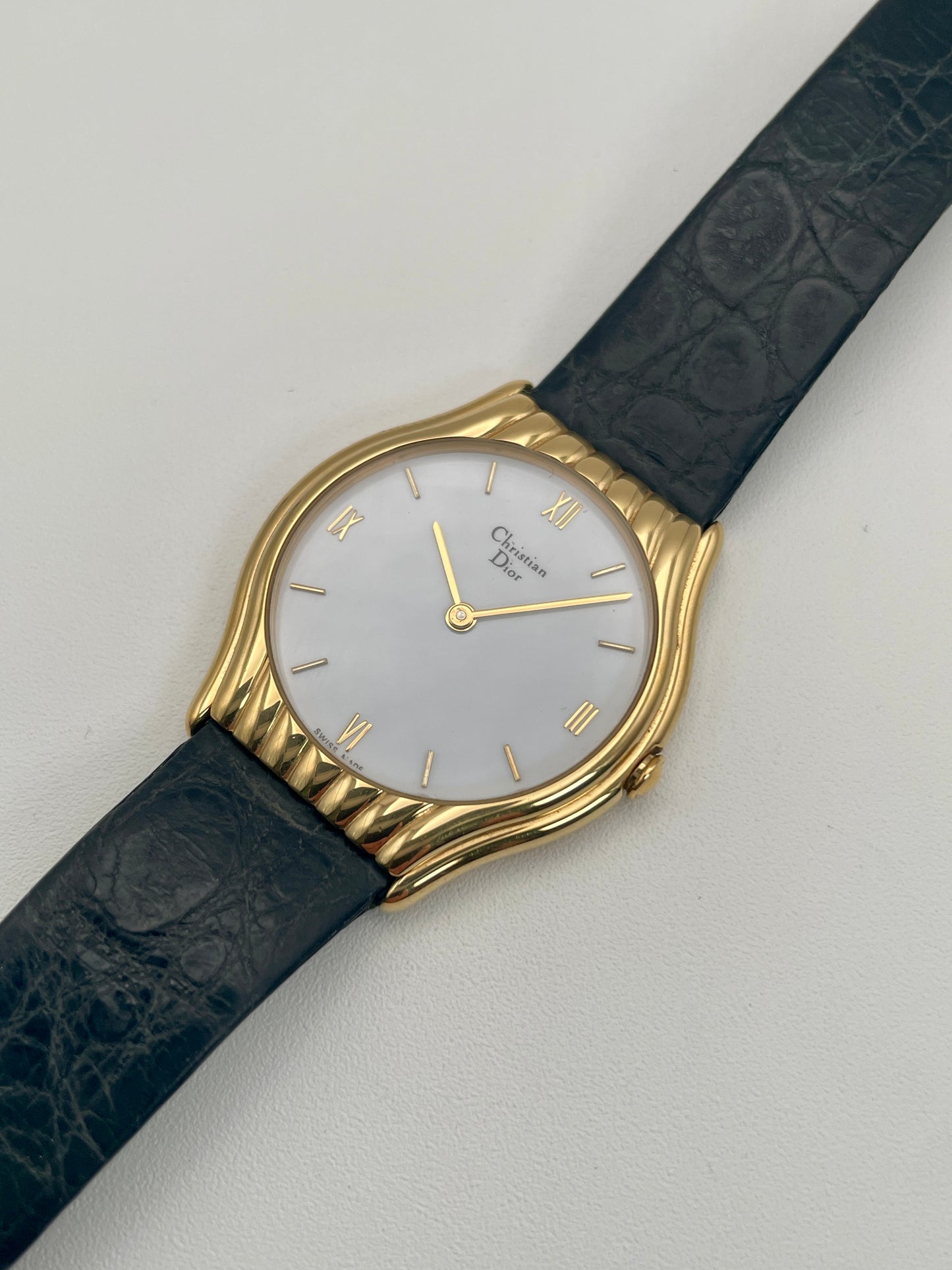 Angled view of Christian Dior 3049 watch showcasing its gold-tone case and elegant Roman numeral markers.