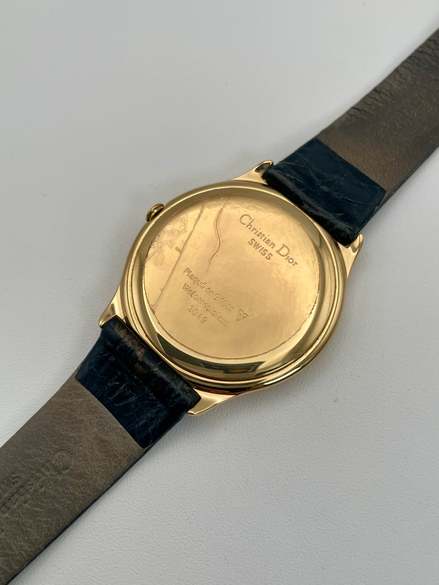 Caseback of Christian Dior 3049 gold-tone watch showing engraved details and original condition.