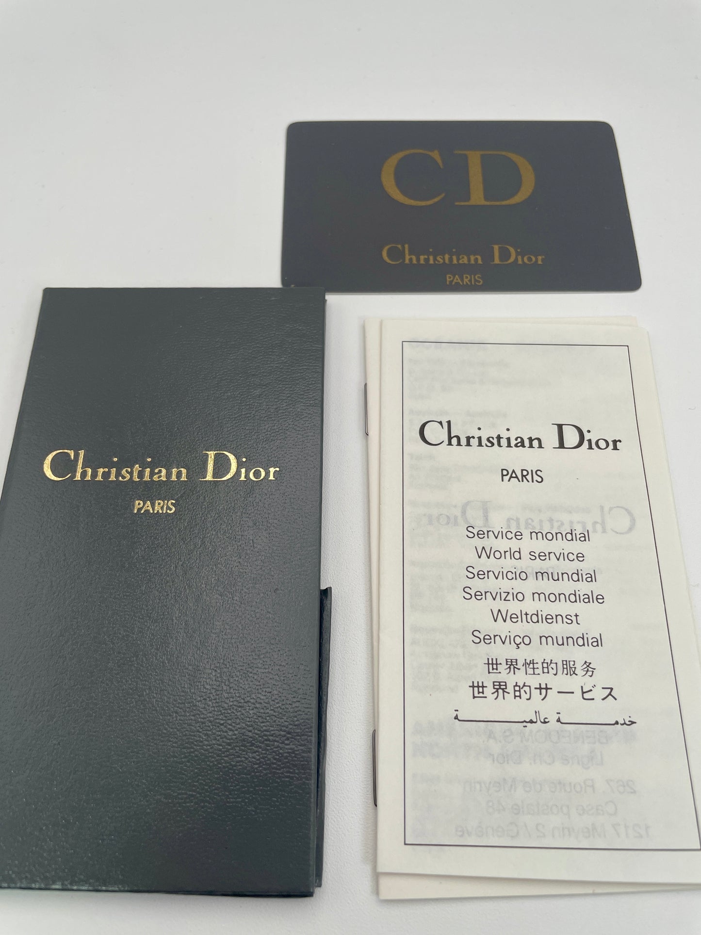 Christian Dior 3049 vintage women's watch with gold case displayed alongside original booklet, CD card, and service papers.