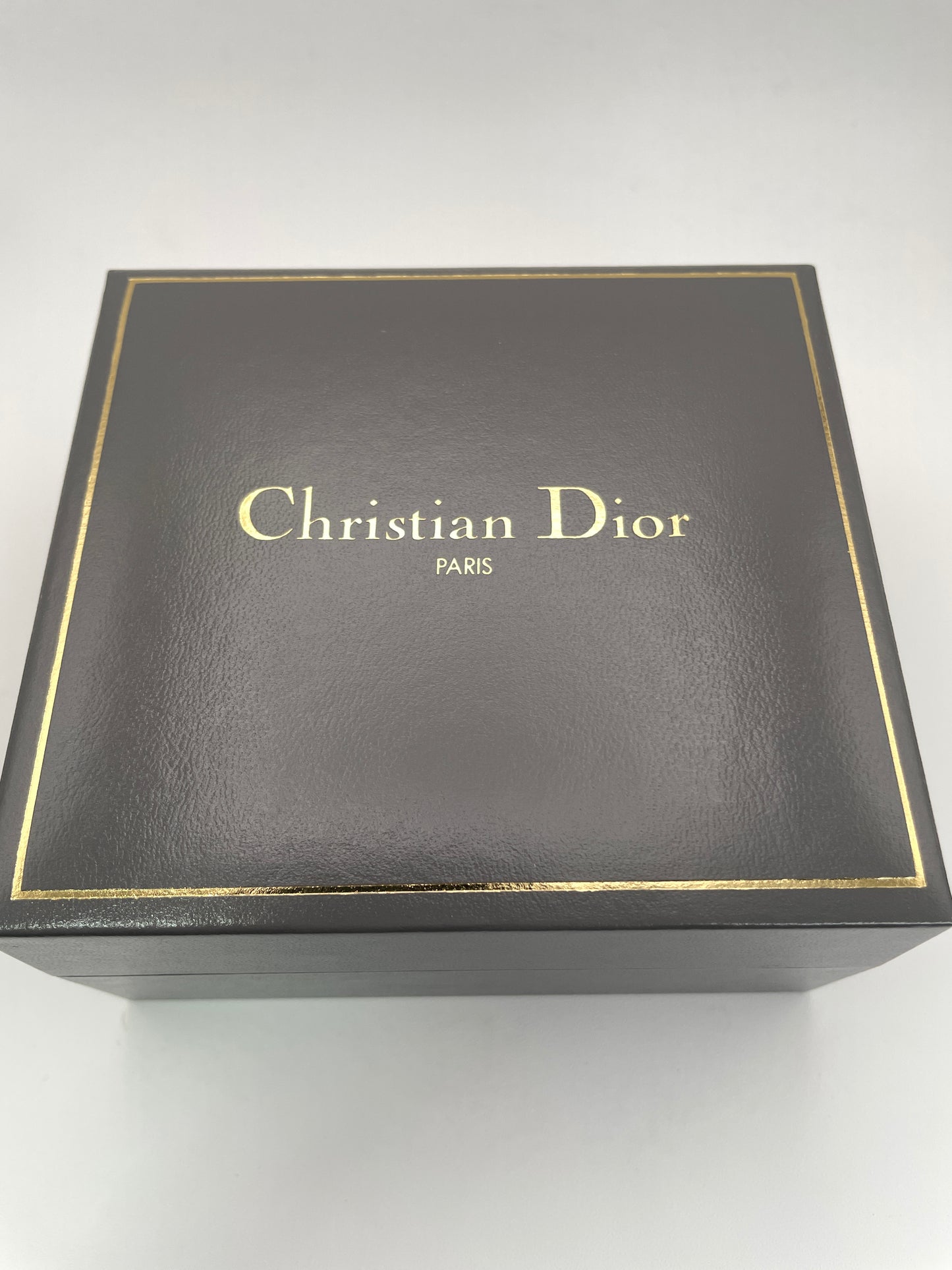 Christian Dior watch box with gold lettering and elegant design, complementing the 48.146 timepiece.