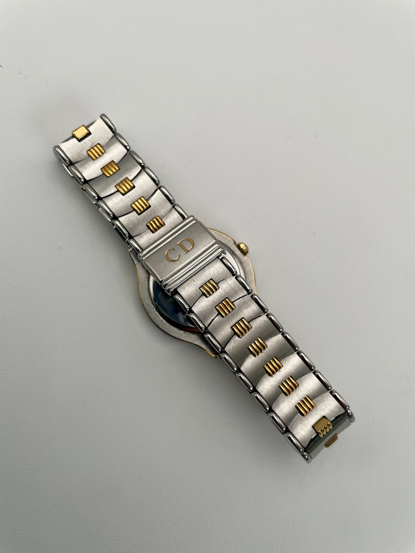 Flat view of Christian Dior 48.146 vintage women's watch highlighting the intricate gold and steel bracelet.