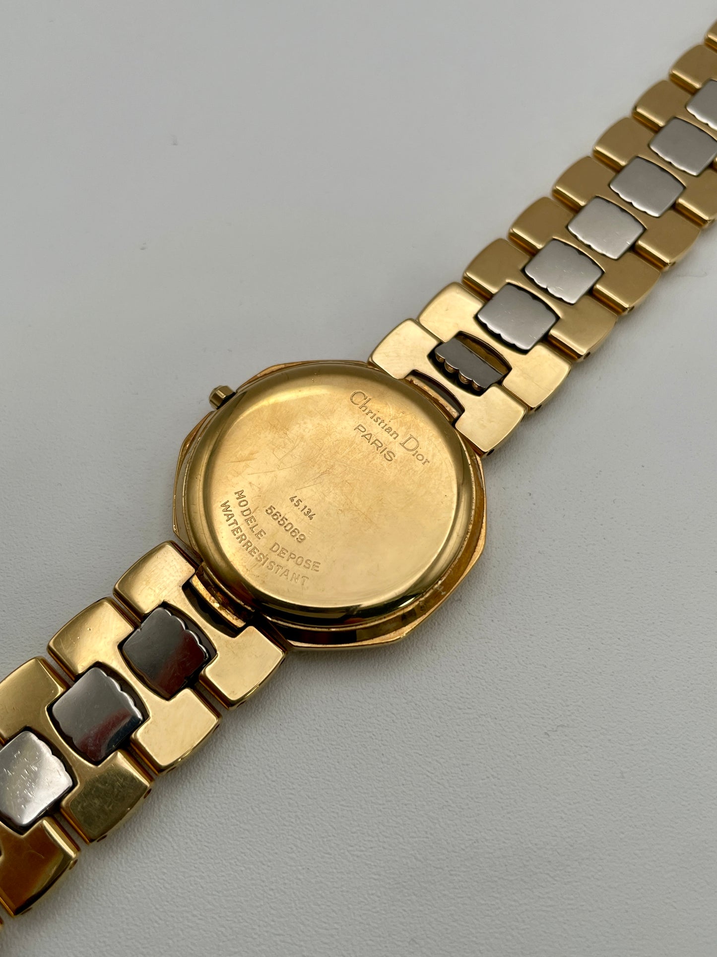 Caseback of Christian Dior Déposé Octagon Vintage Women's Watch featuring engraved Dior branding on the two-tone bracelet.