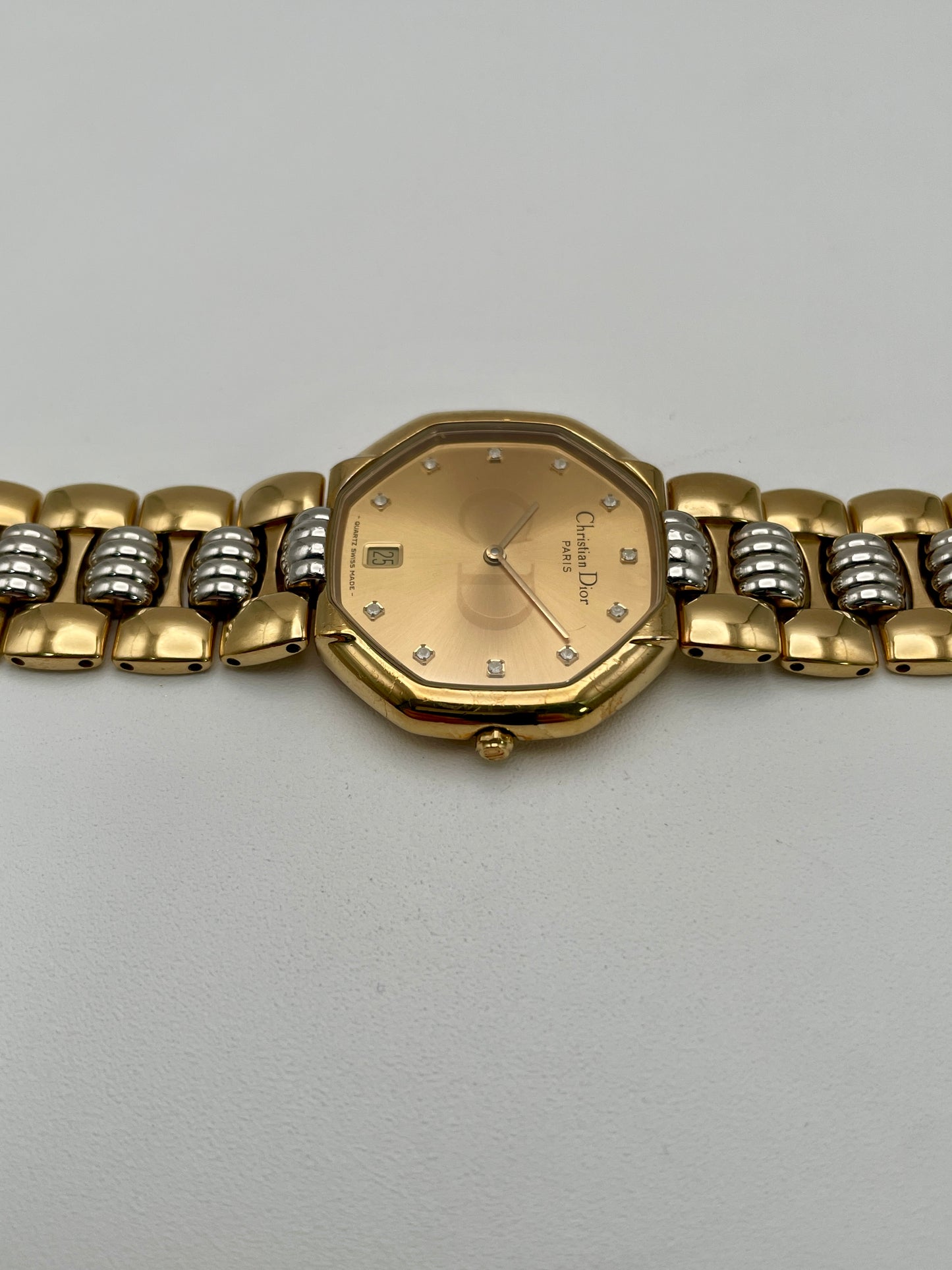 Christian Dior Déposé Octagon Vintage Women's Watch laid flat, highlighting the champagne dial and two-tone bracelet.