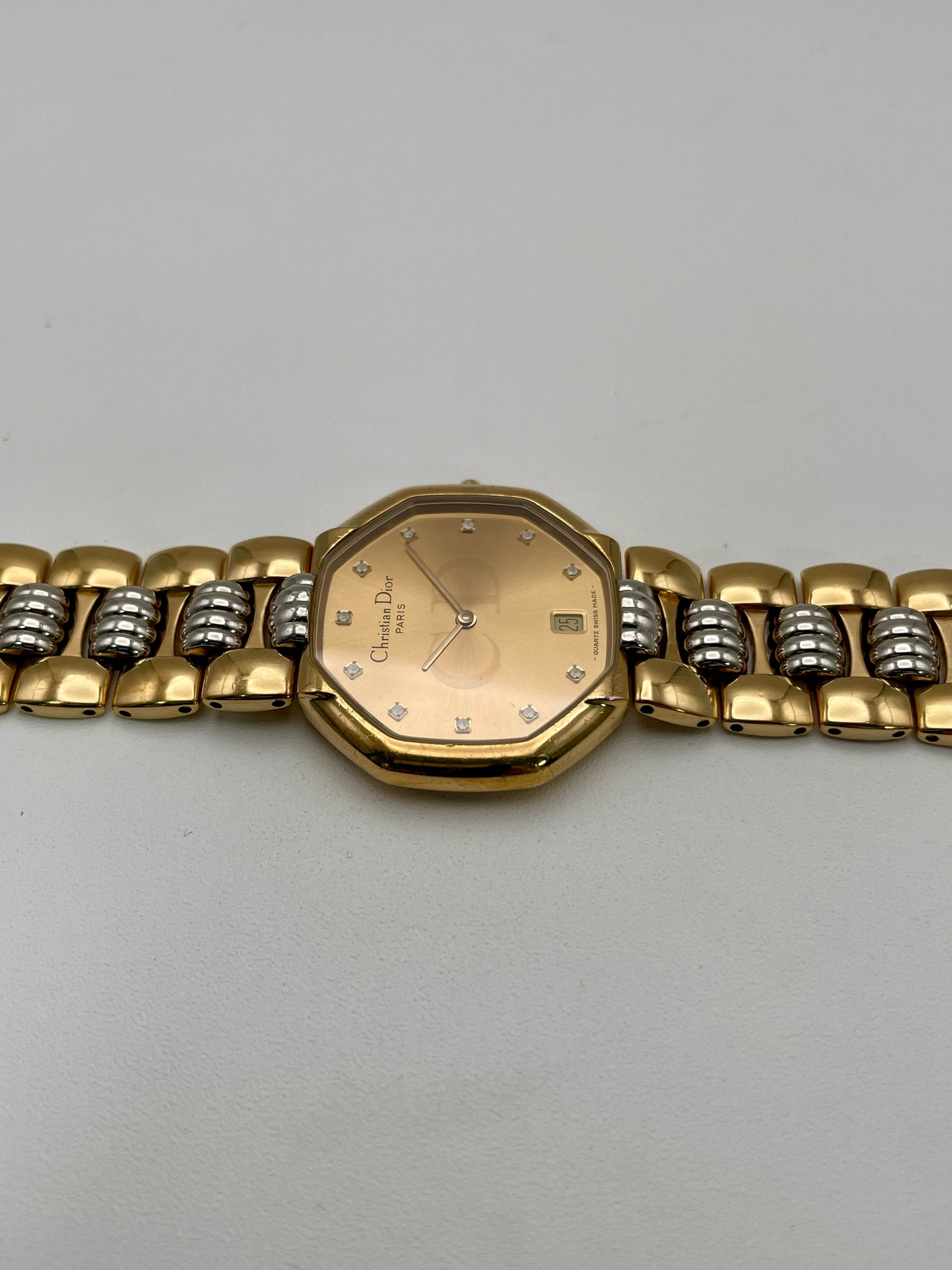 Christian Dior Déposé Octagon Vintage Women's Watch laid flat, highlighting the champagne dial and two-tone bracelet.