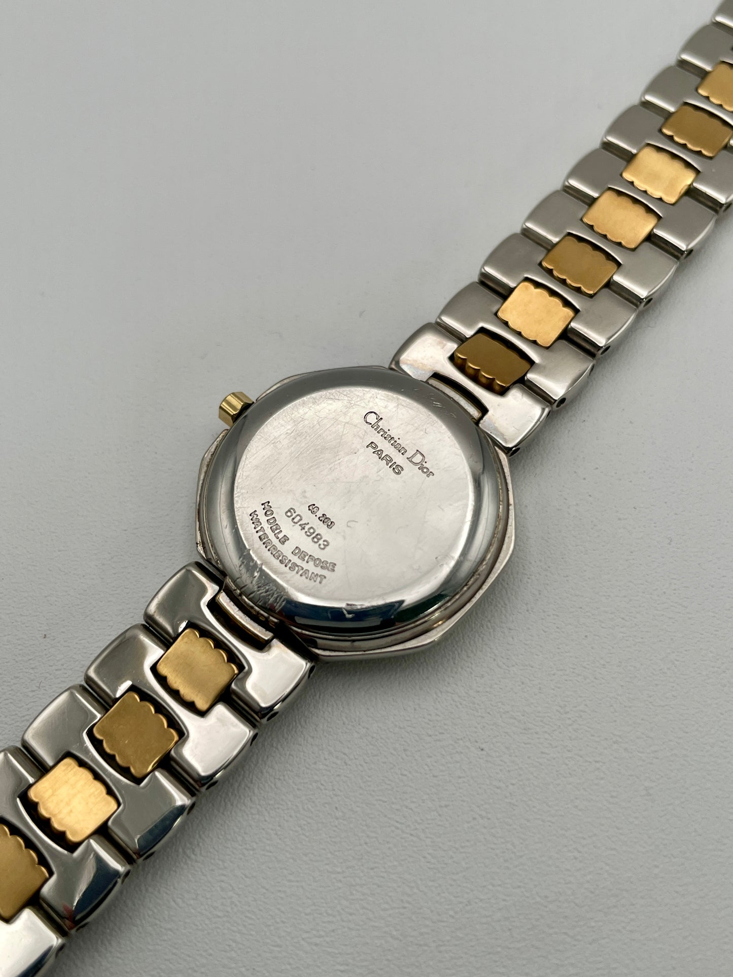Caseback of Christian Dior Déposé Octagon Vintage Women's Watch, featuring engraved branding and a polished steel finish.