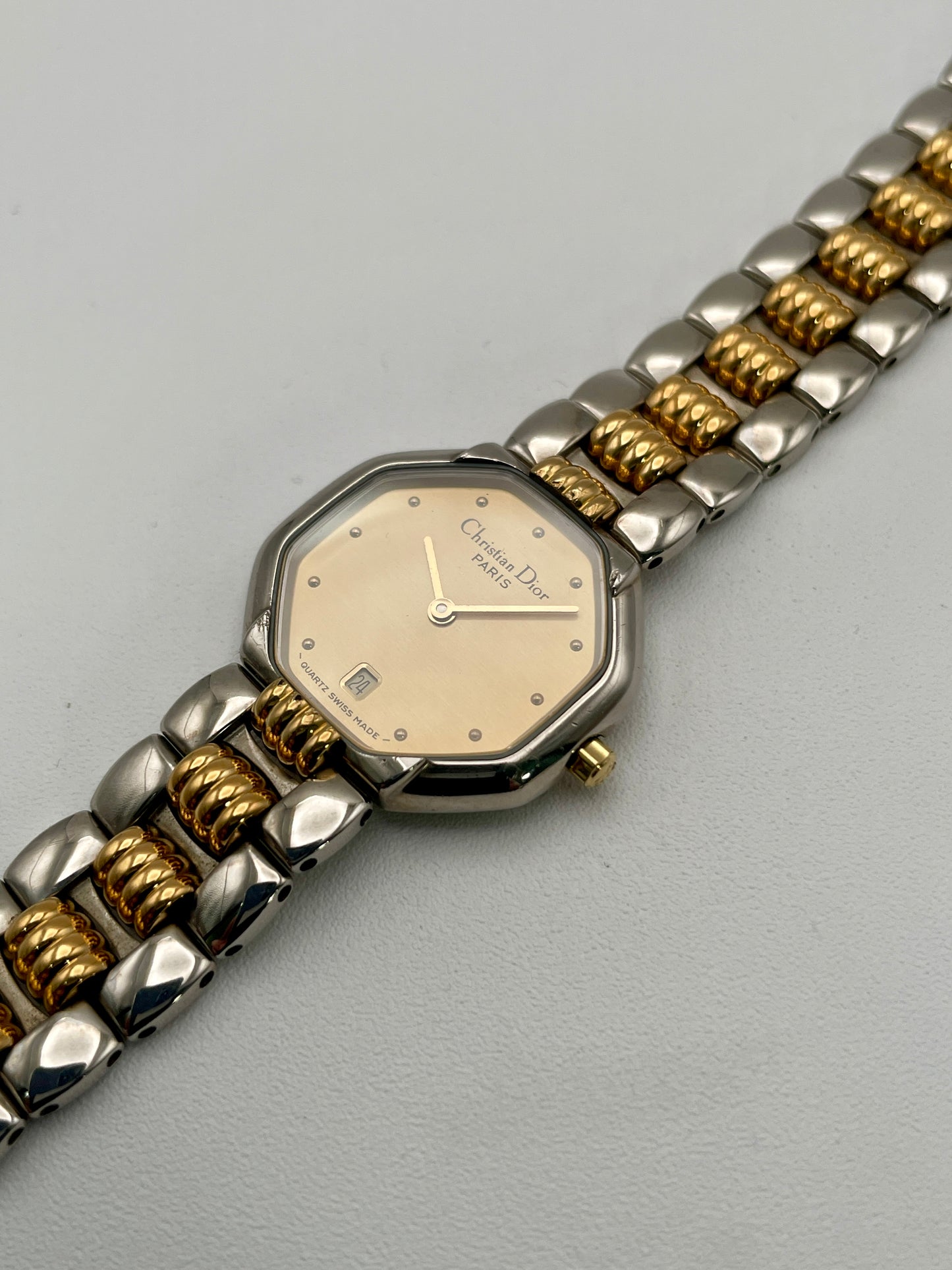Diagonal view of Christian Dior Déposé Octagon Vintage Women's Watch showing the case and bracelet details with gold accents.