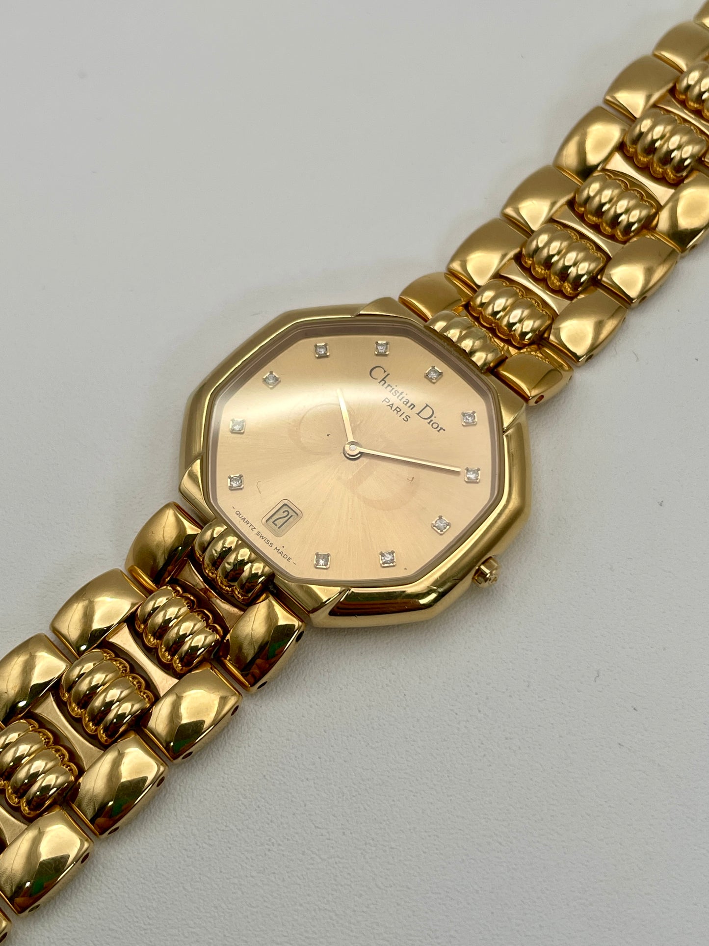 Angled view of the Christian Dior Depose Vintage Women's Watch, highlighting the diamond markers on the gold dial and bracelet details.