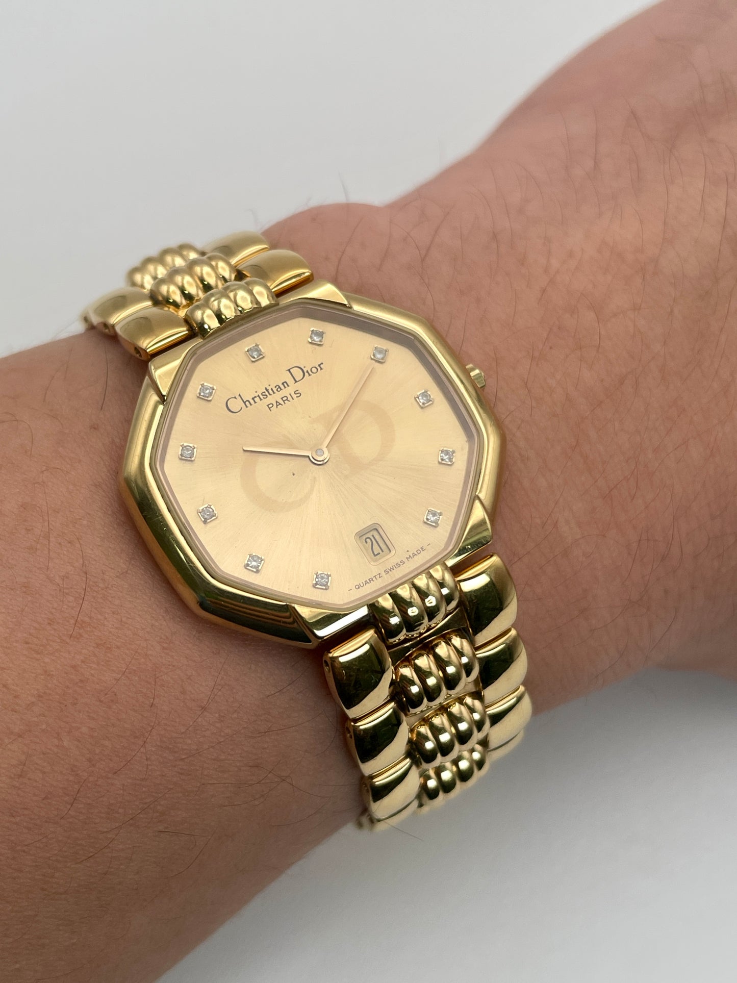Christian Dior Depose Vintage Women's Watch in gold, displayed on wrist, showcasing the octagonal dial and textured link bracelet.