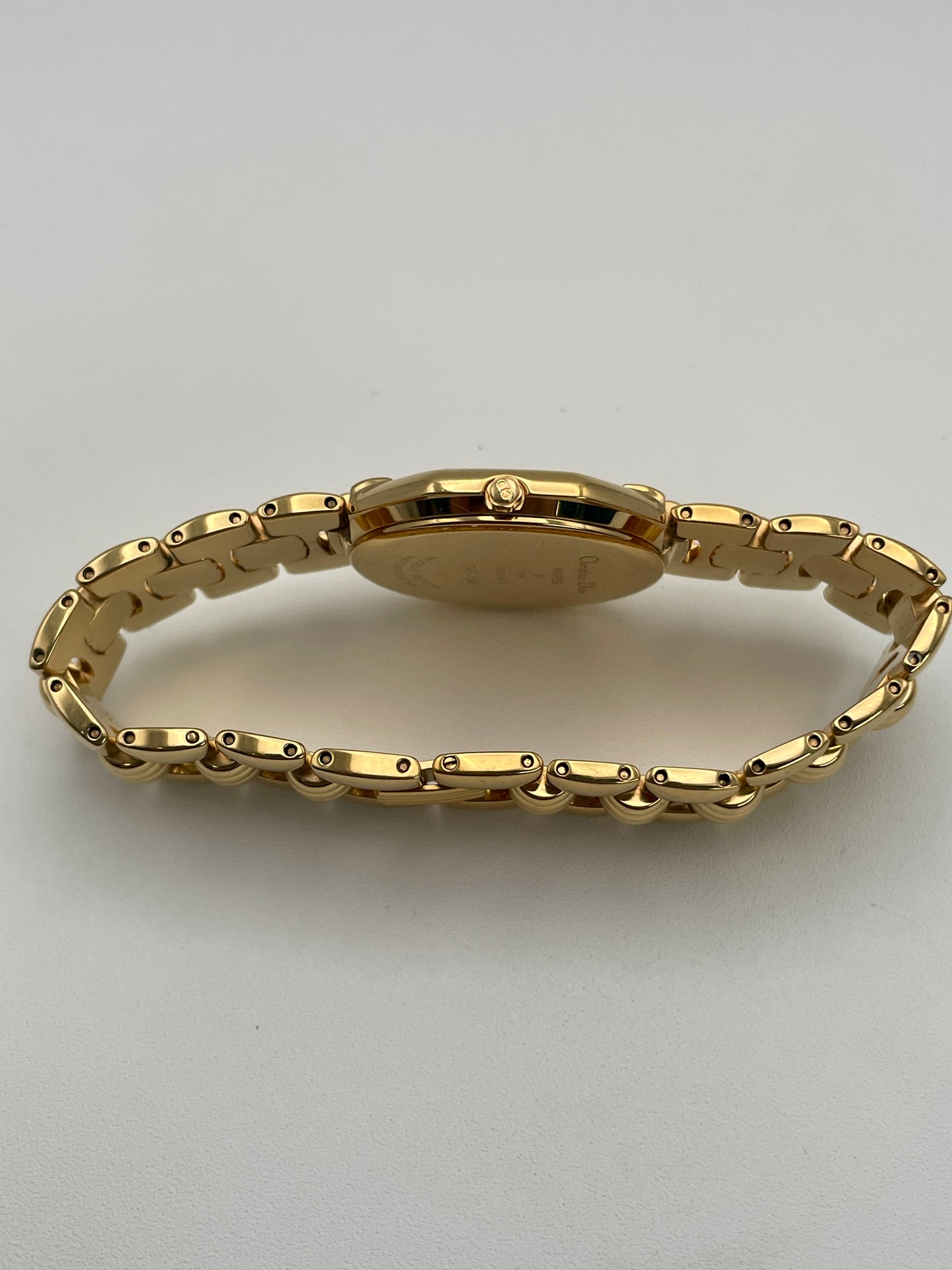 Side view of the Christian Dior Depose Vintage Women's Watch in gold, showcasing the crown, slim profile and gold bracelet.