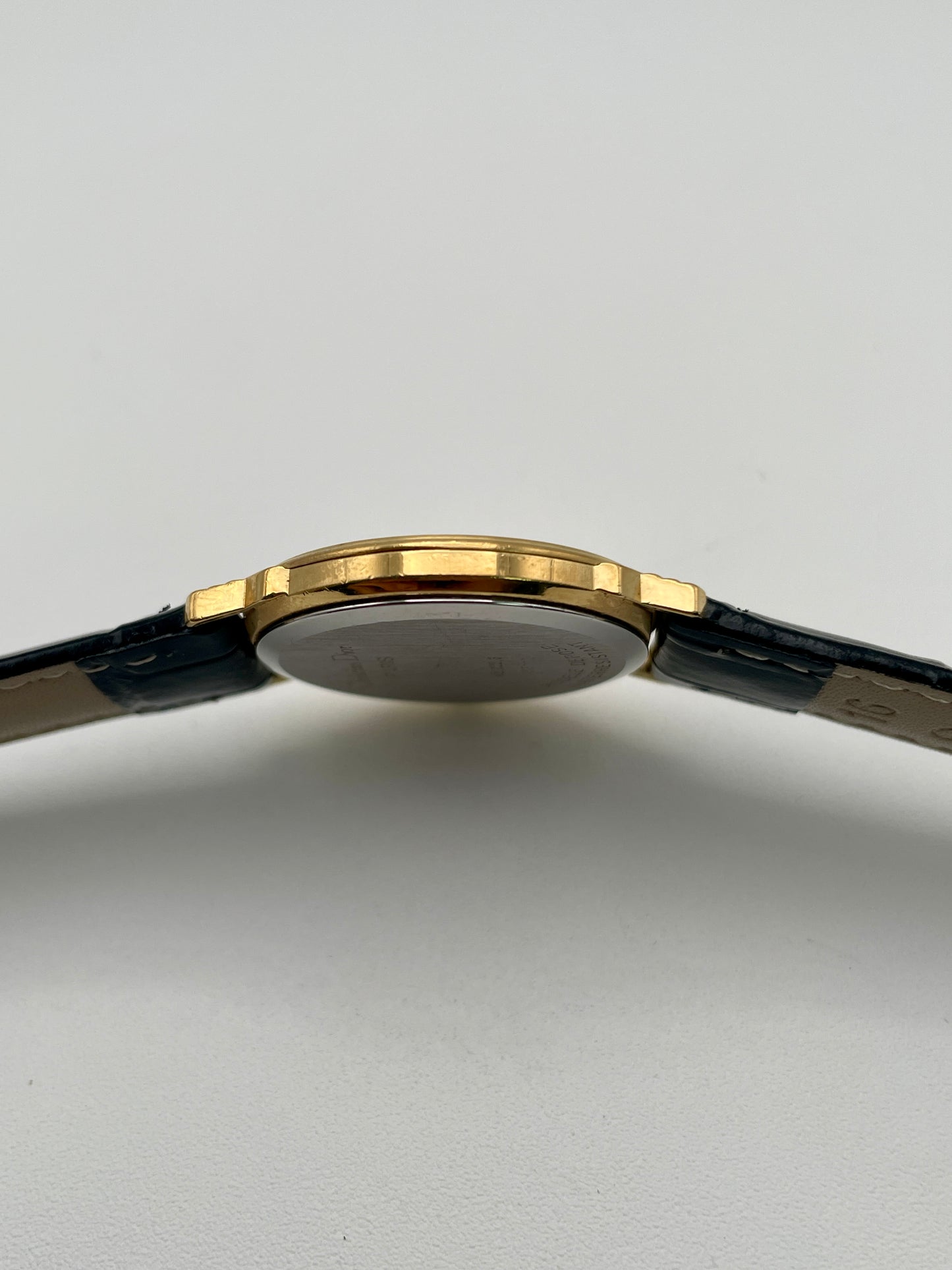 Side view of Christian Dior 45.122 gold-tone case showing slim profile