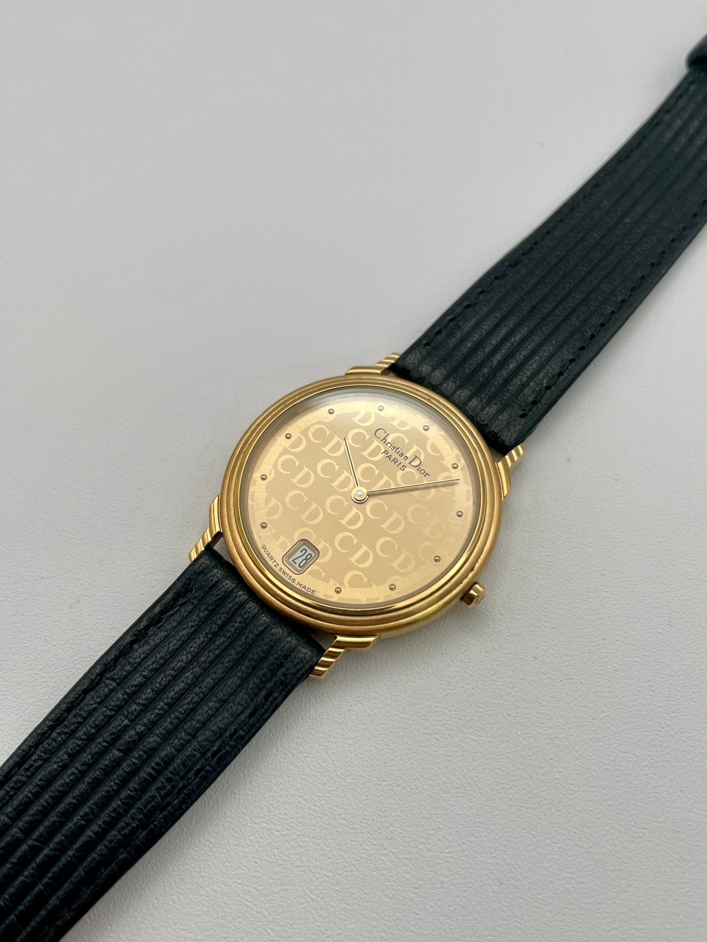 Christian Dior 45.122 vintage women's watch with gold case and ribbed strap, angled right view