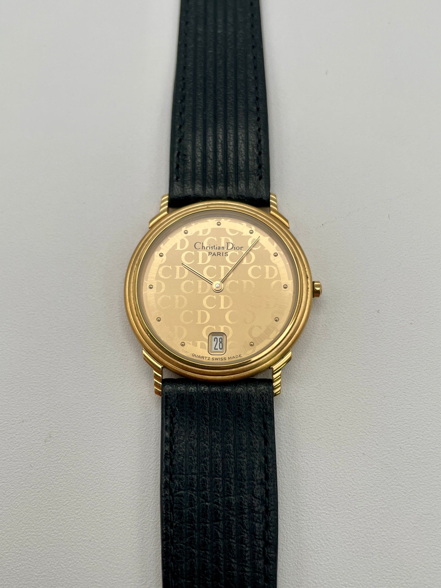 Christian Dior 45.122 watch with CD monogram dial and black ribbed leather strap, front view