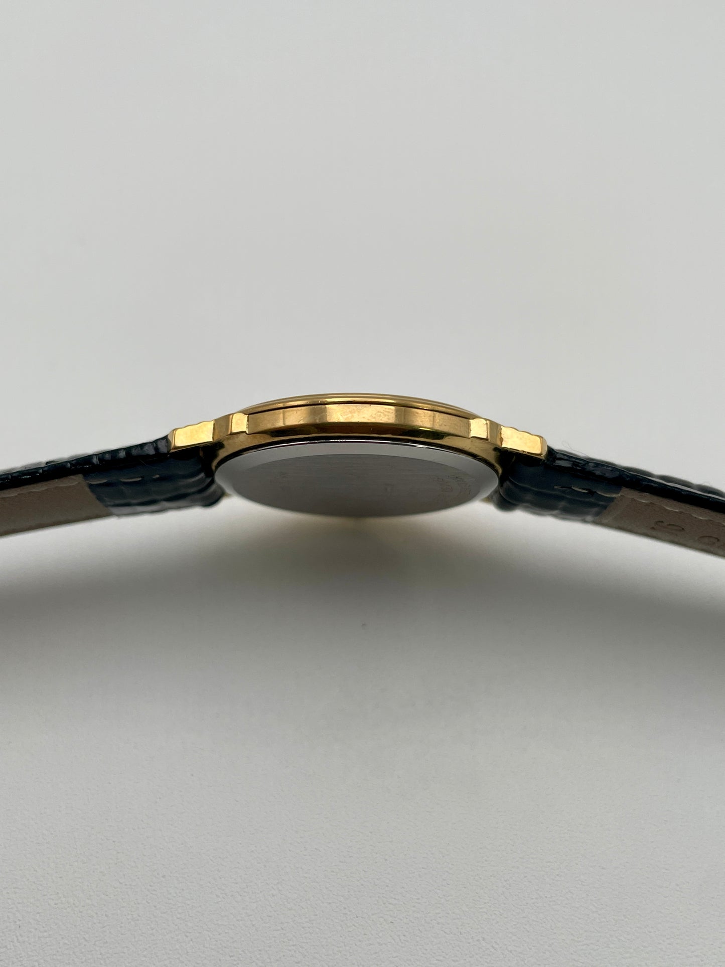 Side view of Christian Dior 48.122.3 Women's Watch emphasizing the slim gold-tone case.
