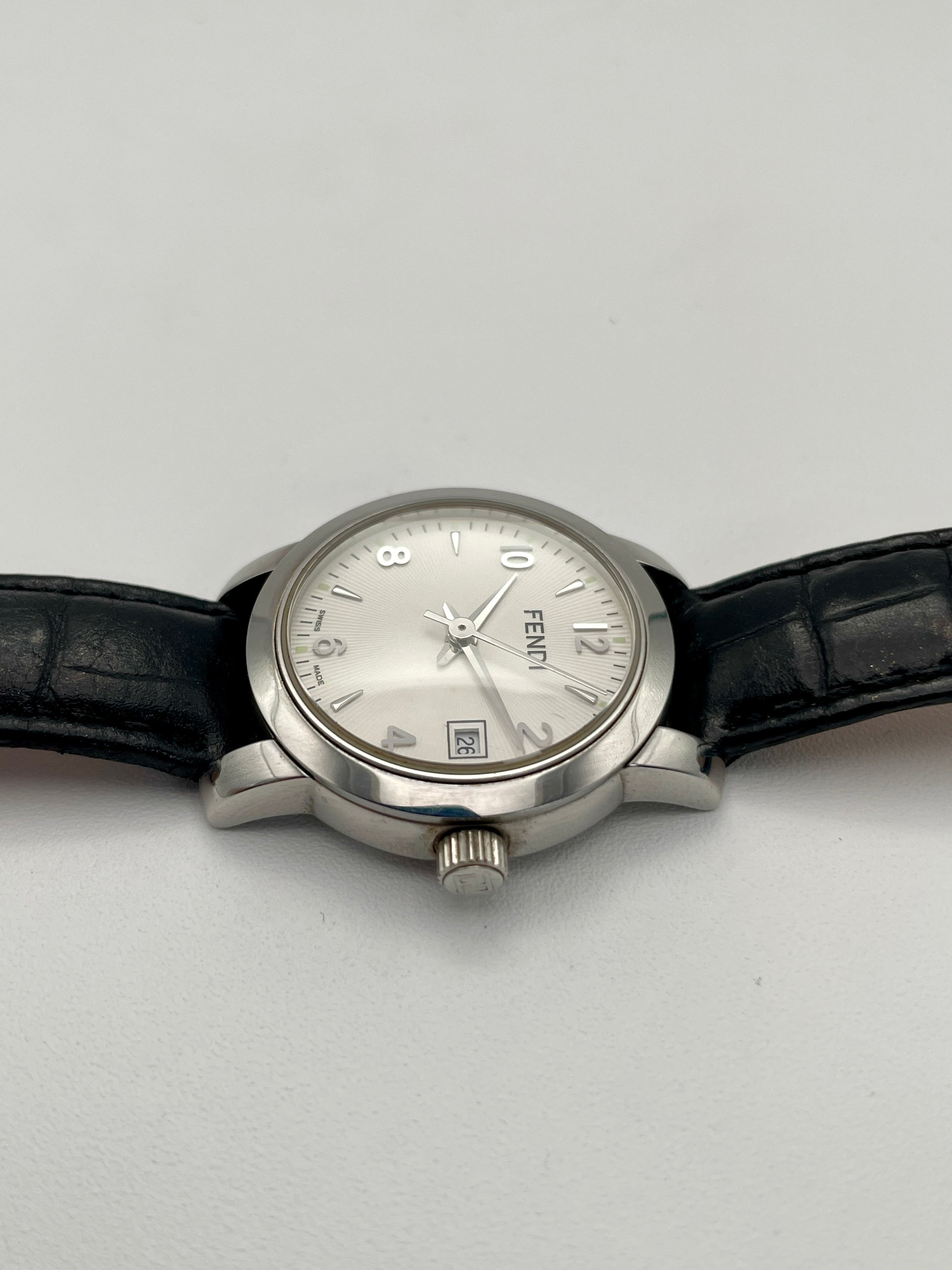 Side crown view of Fendi 2100L watch showcasing the silver dial and textured leather strap