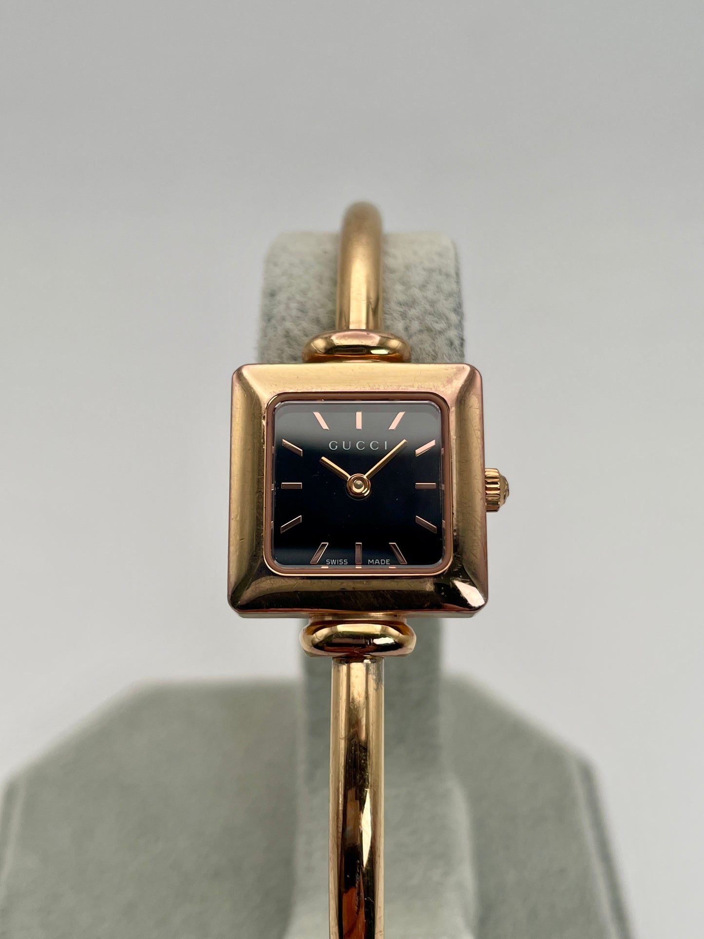Front view of the Gucci 1900L vintage women's watch with a gold-tone steel case and black dial.