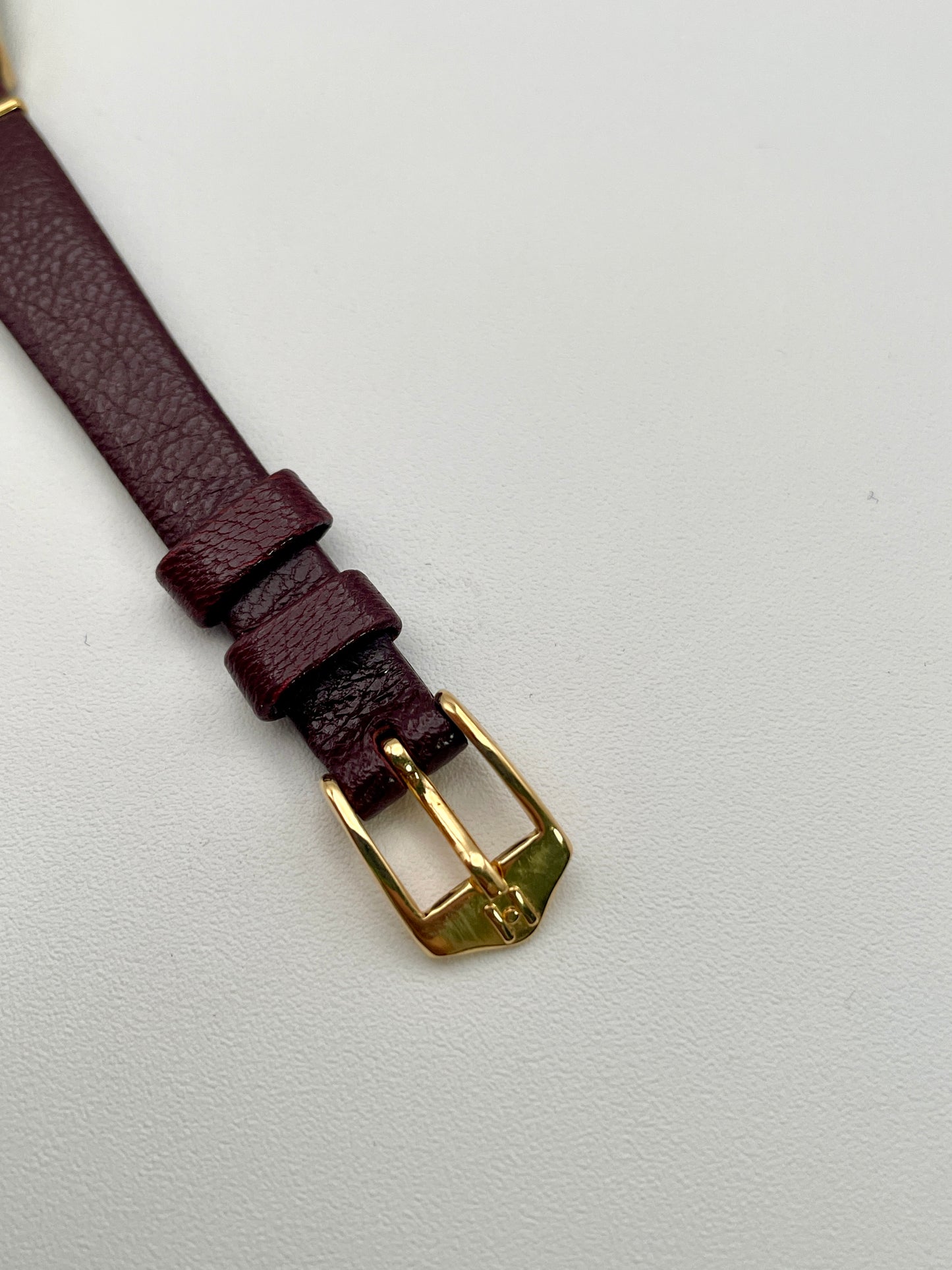 Close-up of the gold-tone buckle on the burgundy leather strap of the Longines Ref. 4139 vintage women's watc