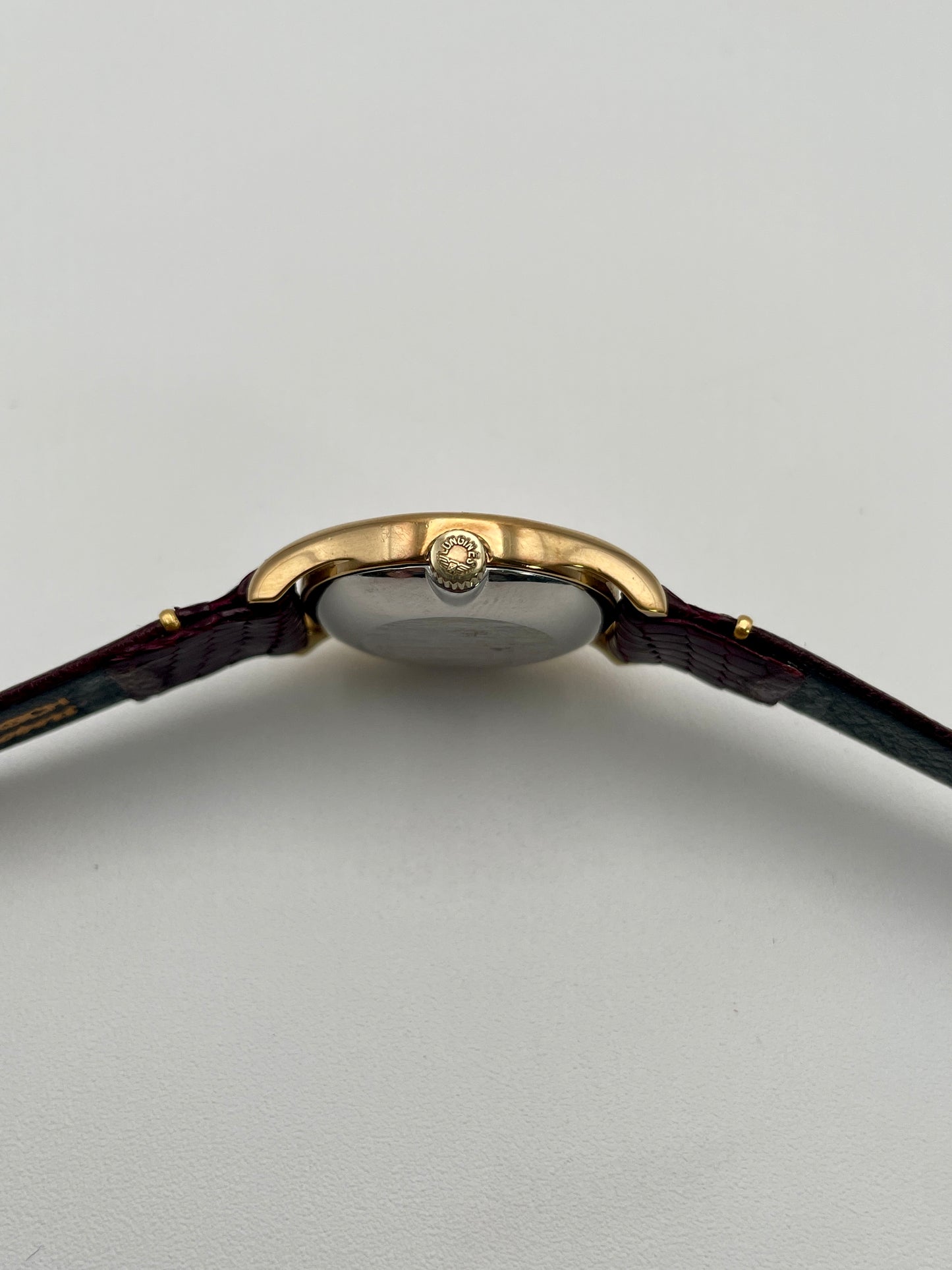 Side view of the Longines Ref. 4139 vintage watch, highlighting the gold-tone crown and slim profile.