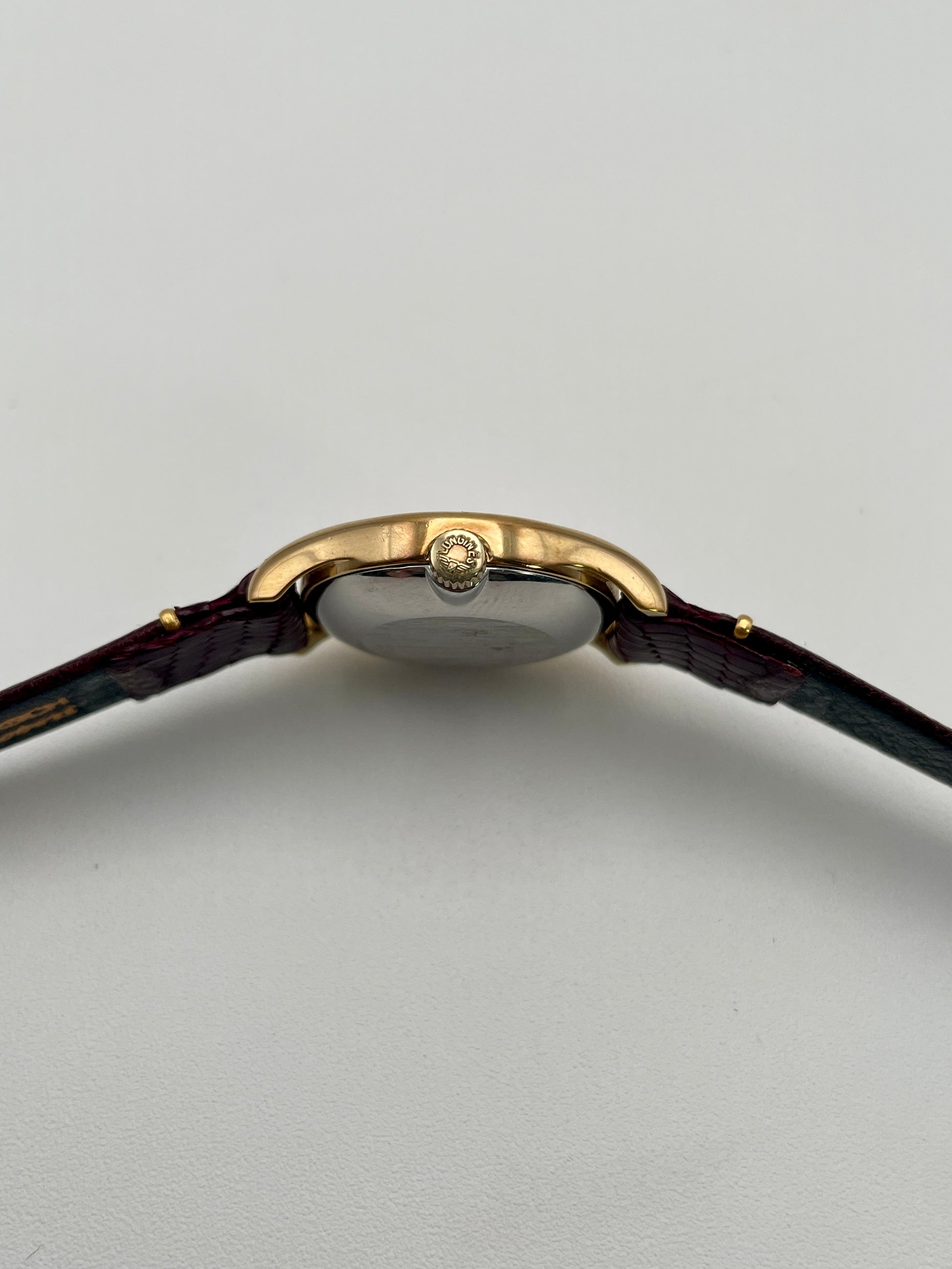 Side view of the Longines Ref. 4139 vintage watch, highlighting the gold-tone crown and slim profile.
