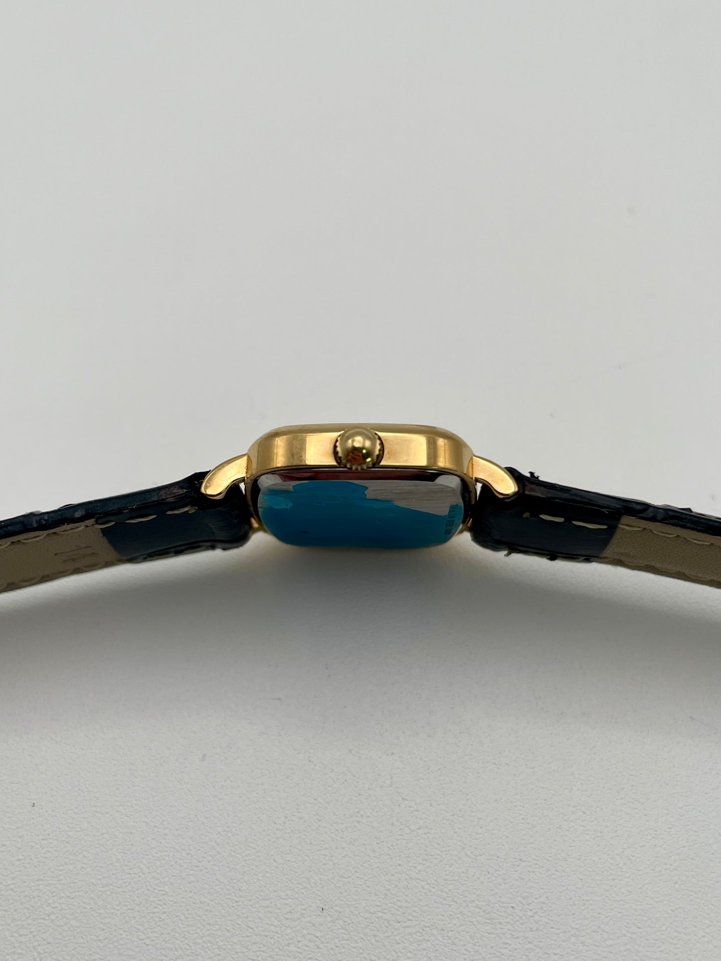 Side view with crown of Longines 6068.2 showcasing gold-tone crown and curved lugs