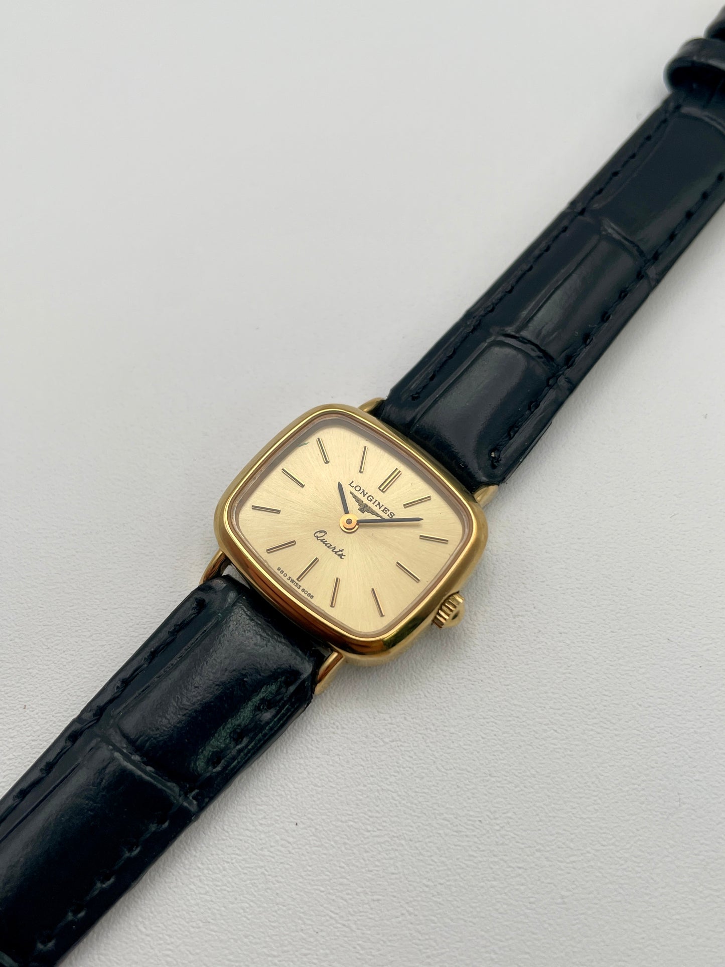 Diagonal view of the Longines 6068.2 vintage women's watch showing champagne dial and gold-tone square case