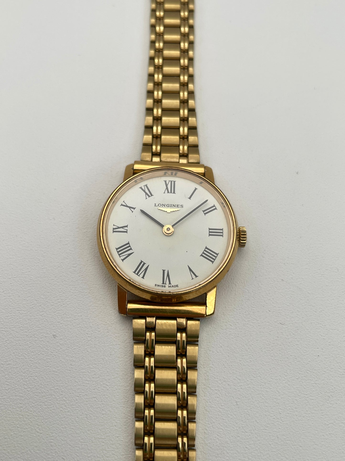 Front view of the Longines Classic Vintage Ladies Watch in Gold featuring a white dial with Roman numerals.