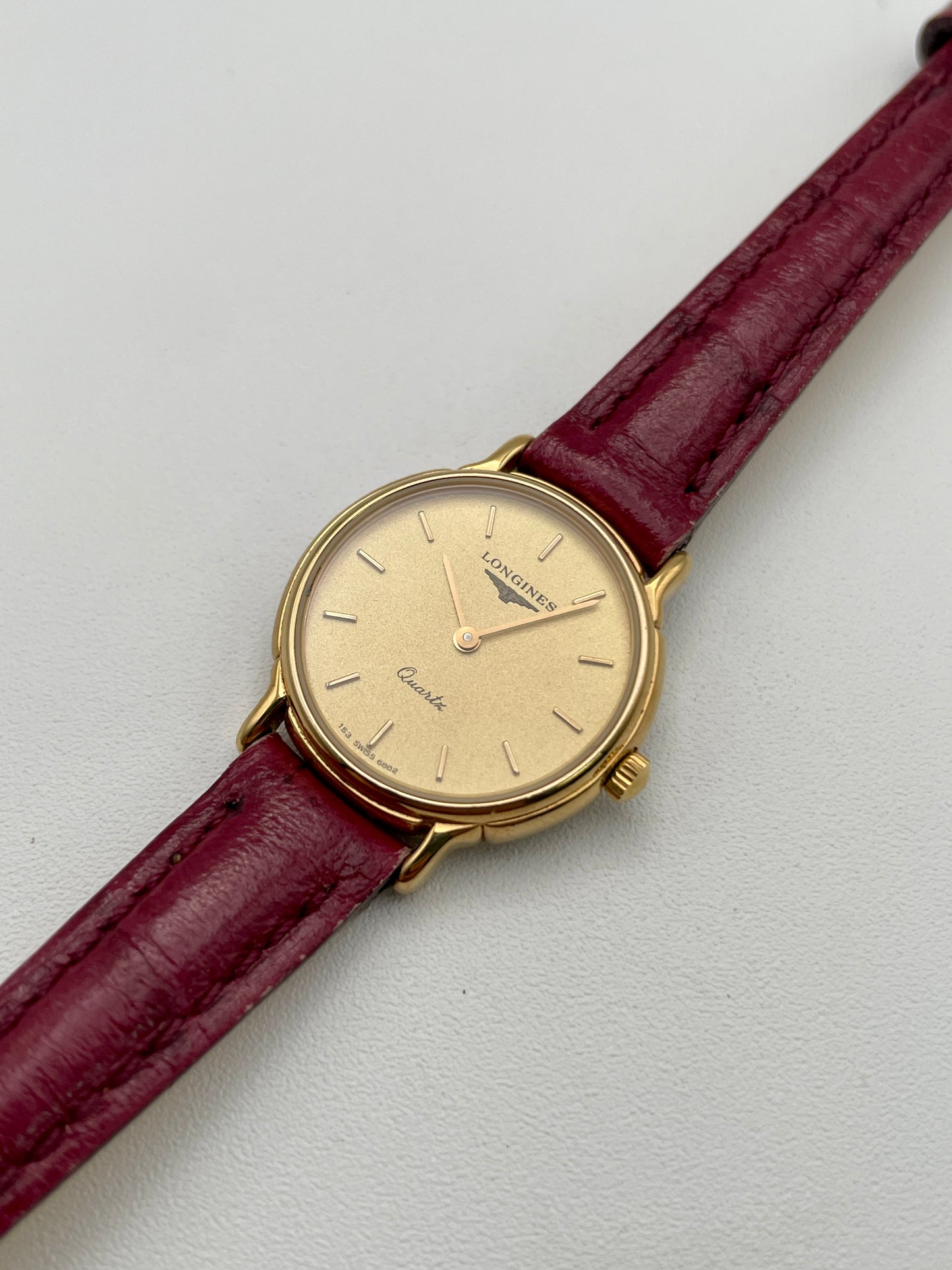 Diagonal right view of Longines L153.4 vintage quartz watch with red leather strap