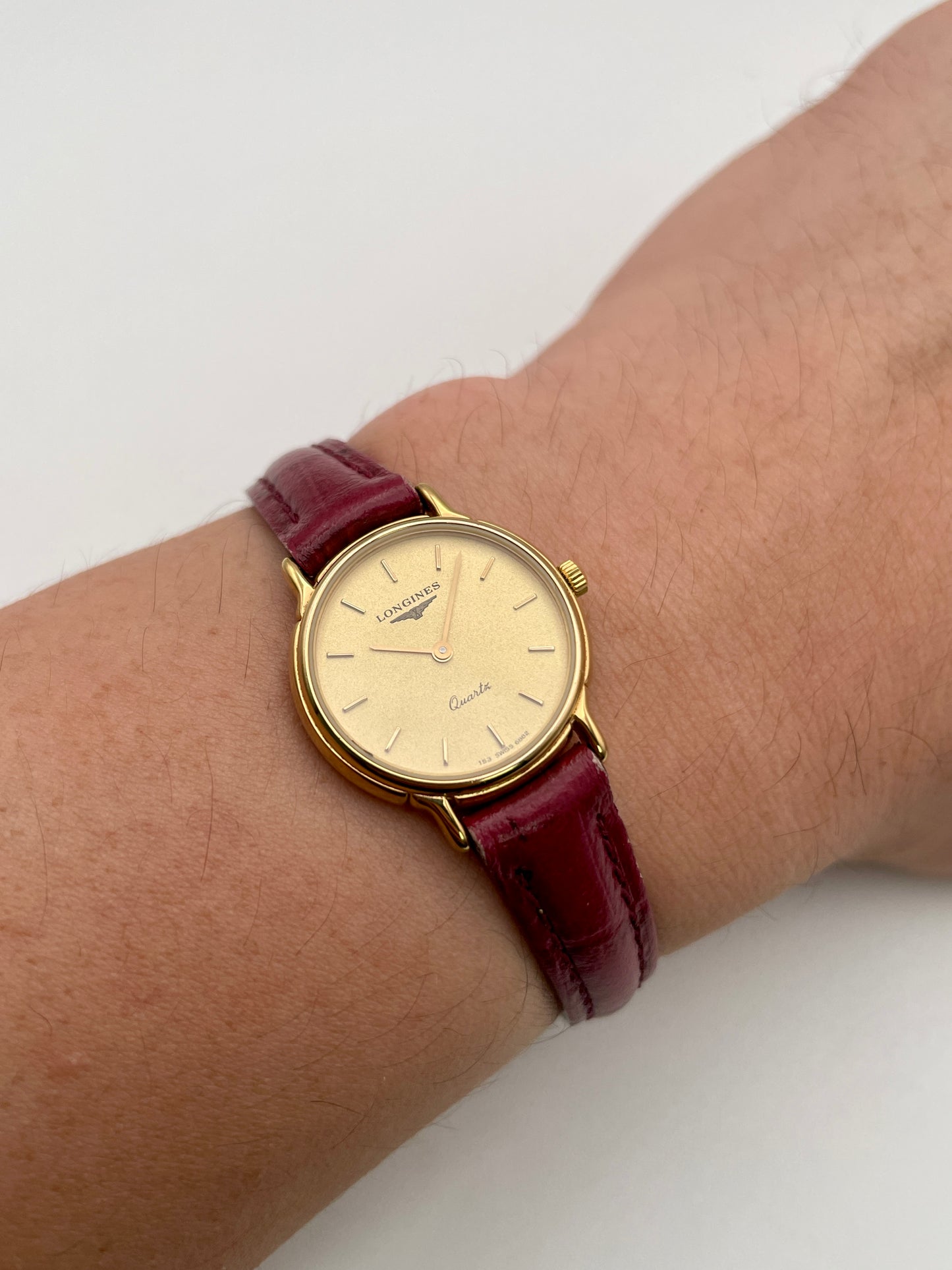 Wrist shot of Longines L153.4 Vintage Women's Watch in gold with red strap