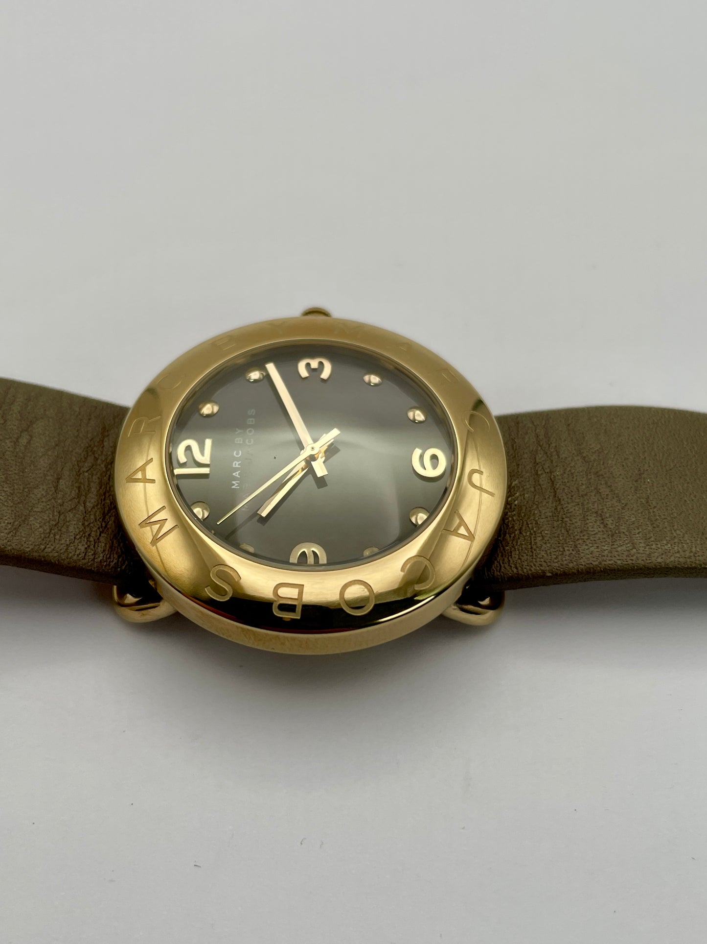 Side view of the Marc by Marc Jacobs watch showcasing the thickness of the gold-tone case and the tan leather strap
