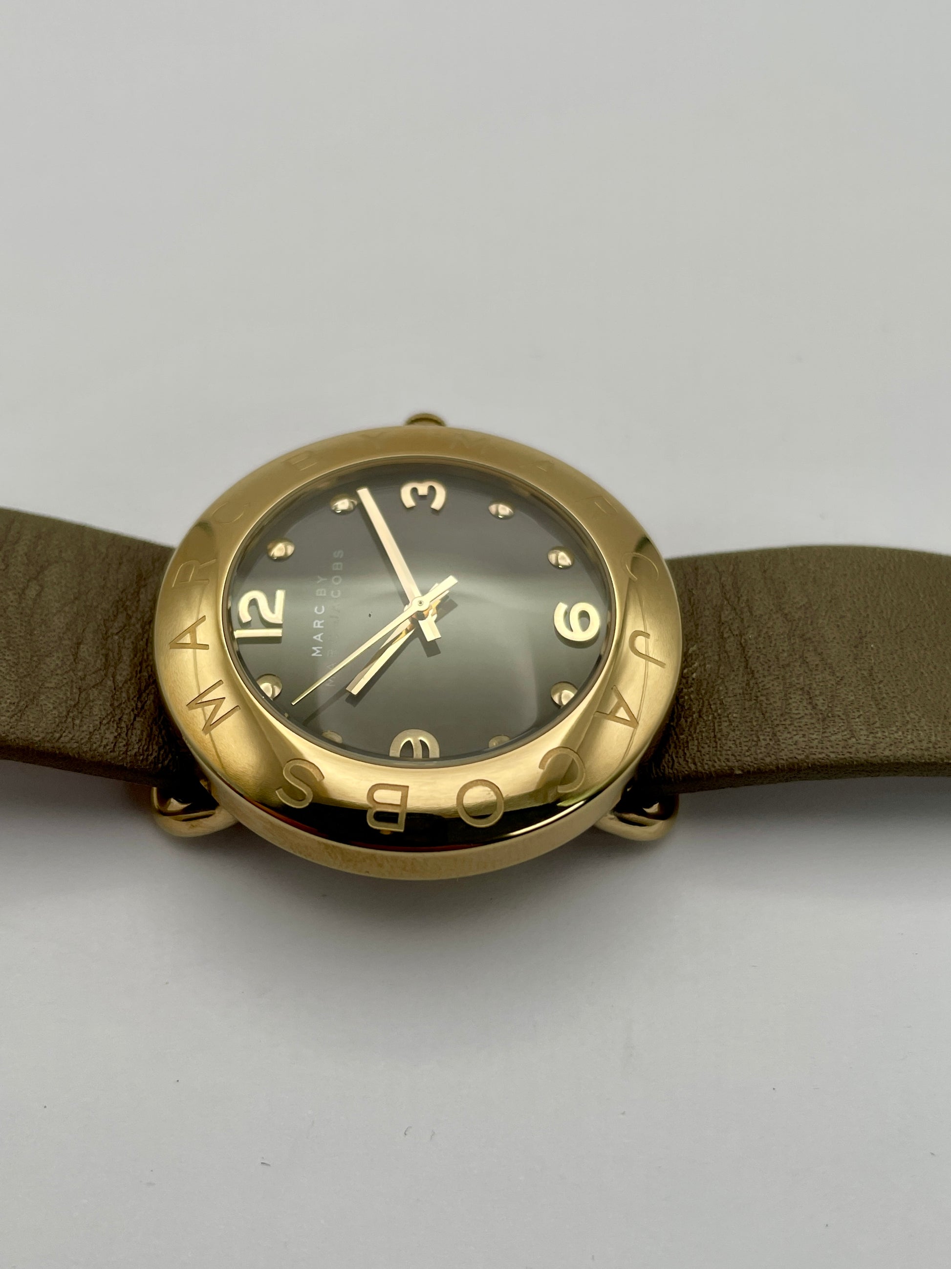 Side view of the Marc by Marc Jacobs watch showcasing the thickness of the gold-tone case and the tan leather strap