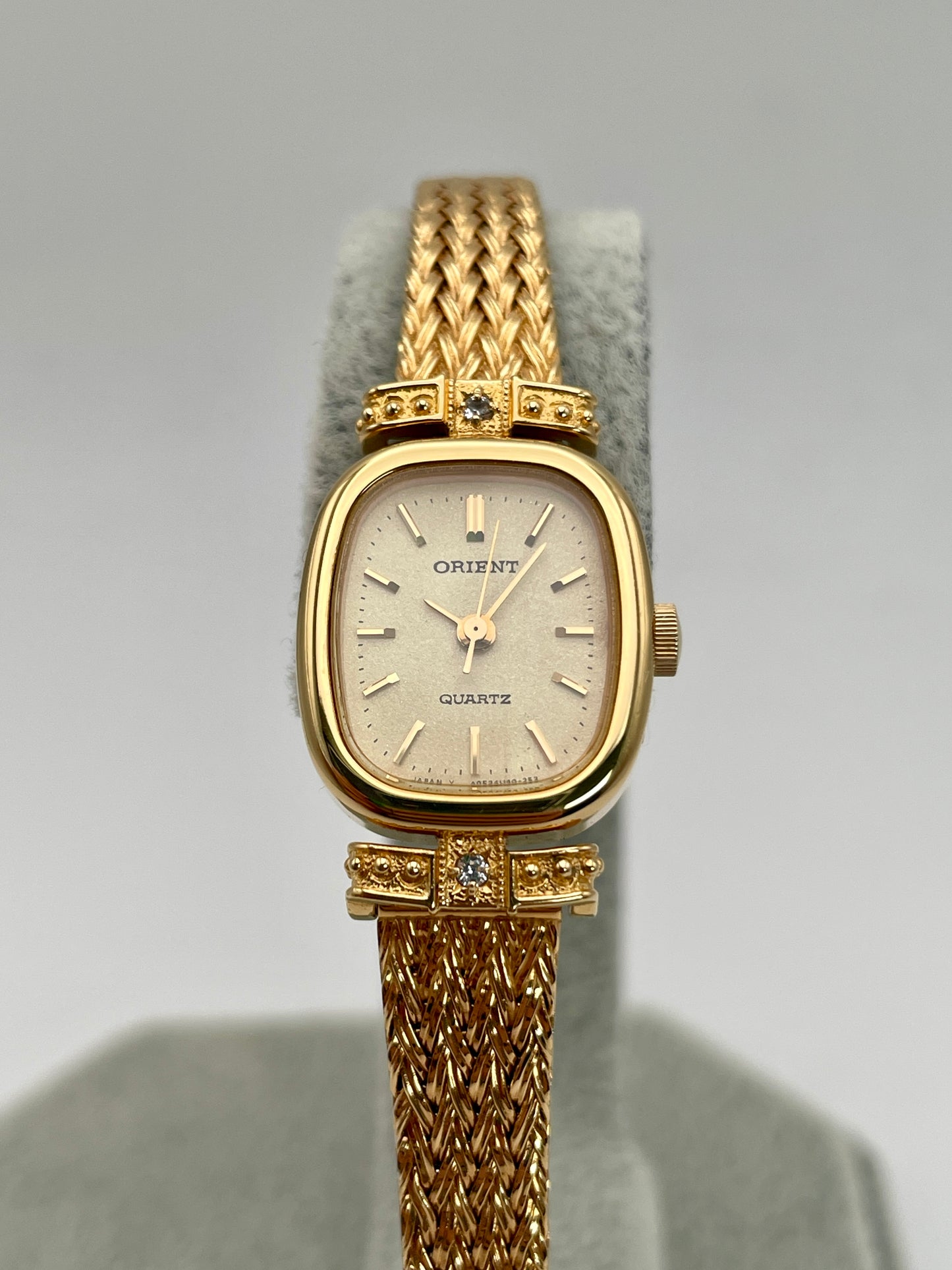 Close-up front view of Orient Vintage Women's Watch with a rectangular gold case and champagne dial.