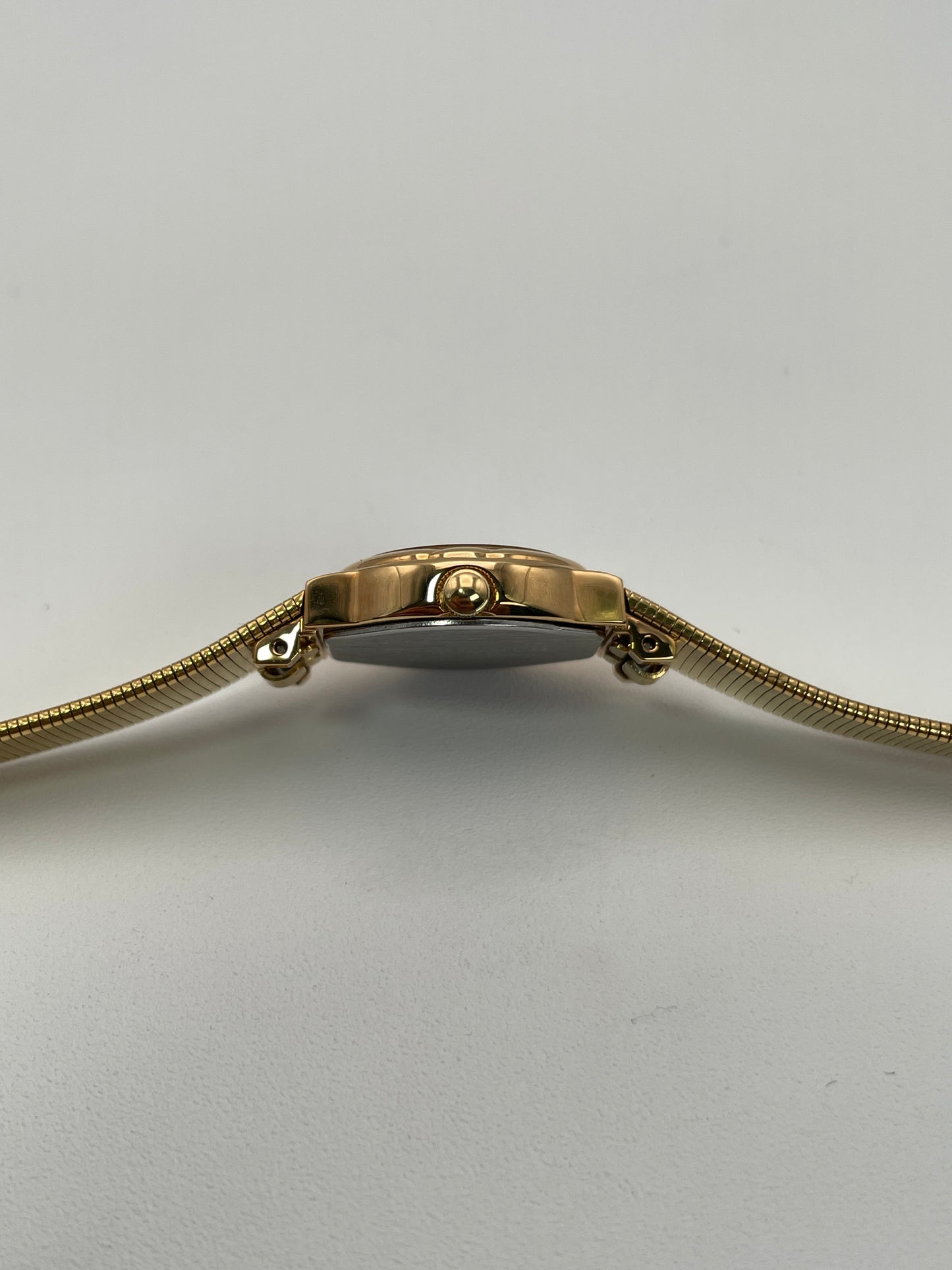 Close-up of the crown and case side on the gold Orient Vintage Women's Watch.