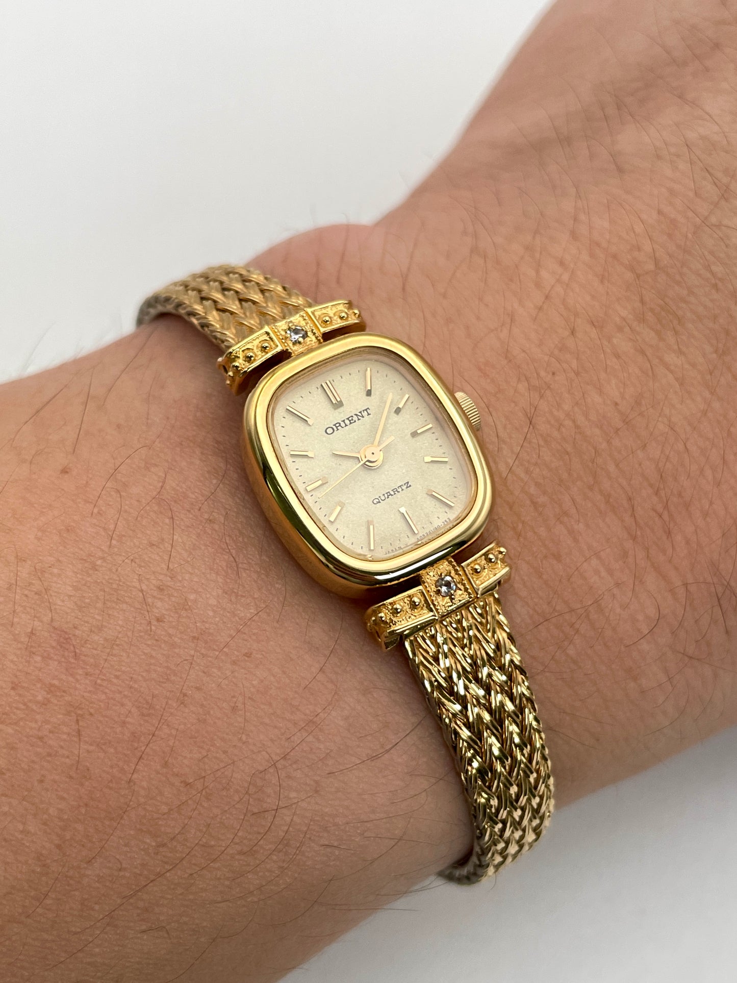 Wrist shot of Orient Vintage Women's Watch in gold with a champagne dial and diamond lugs.