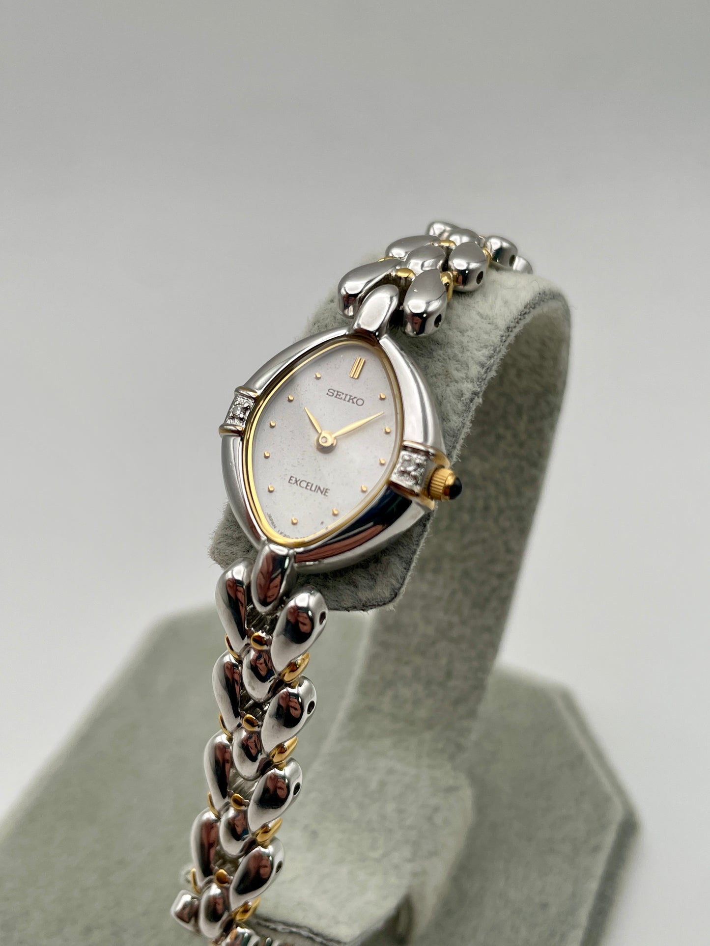 Seiko Exceline watch diagonally placed, highlighting teardrop case and minimalist face