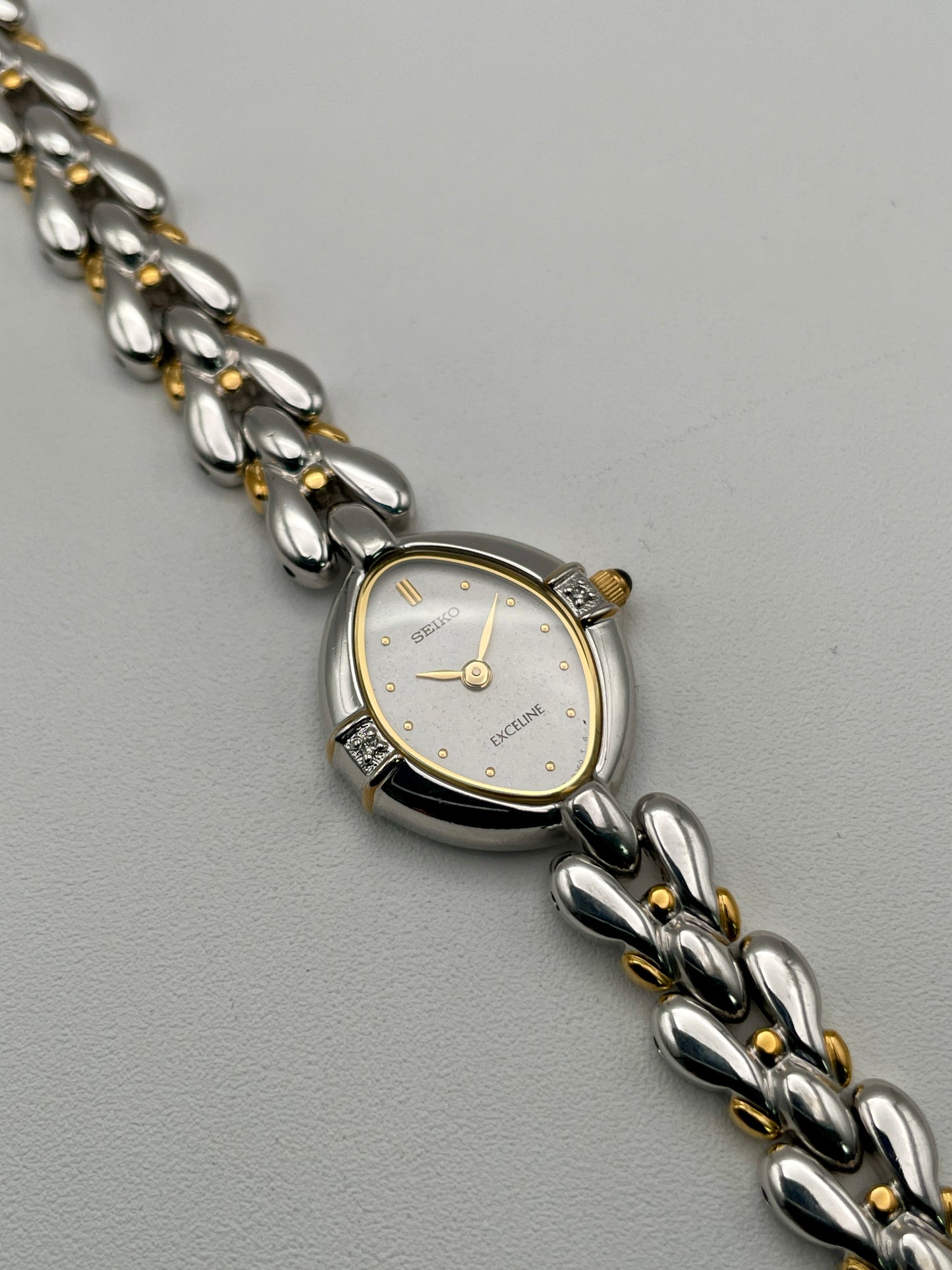 Seiko Exceline vintage watch showing off-center angle of white dial and unique bracelet links