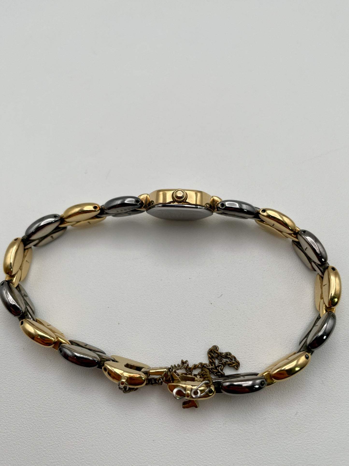 Crown-side view of Seiko Hexagon watch with unique bracelet link details and safety chain