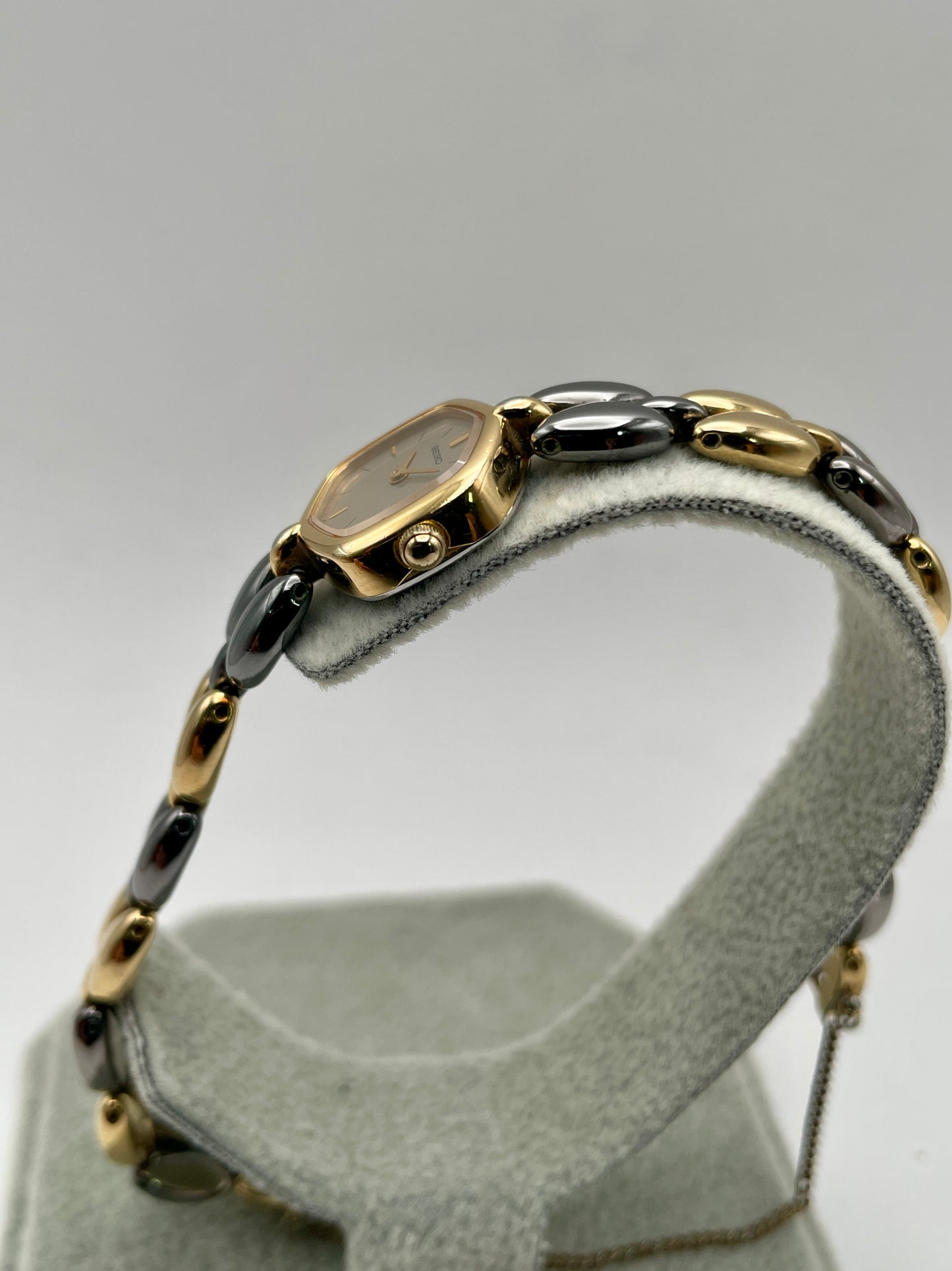 Crown-side view of Seiko Hexagon watch with unique bracelet link details and safety chain