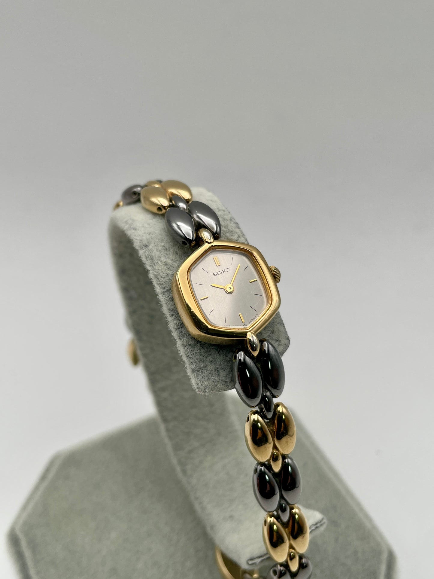 Front view of Seiko Hexagon 1E20-5460 showing silver dial and gold hexagonal case