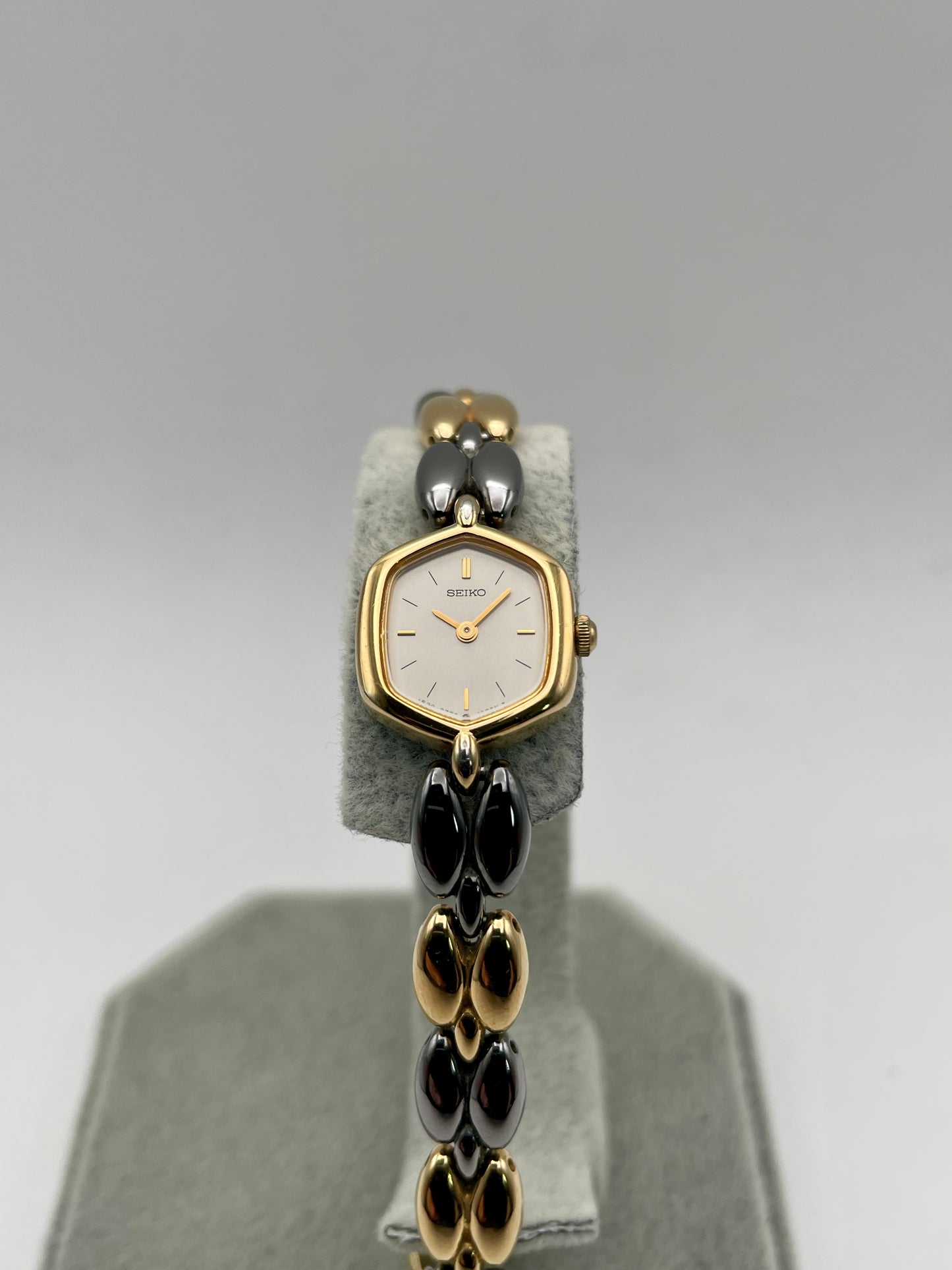 Front view of Seiko Hexagon 1E20-5460 showing silver dial and gold hexagonal case