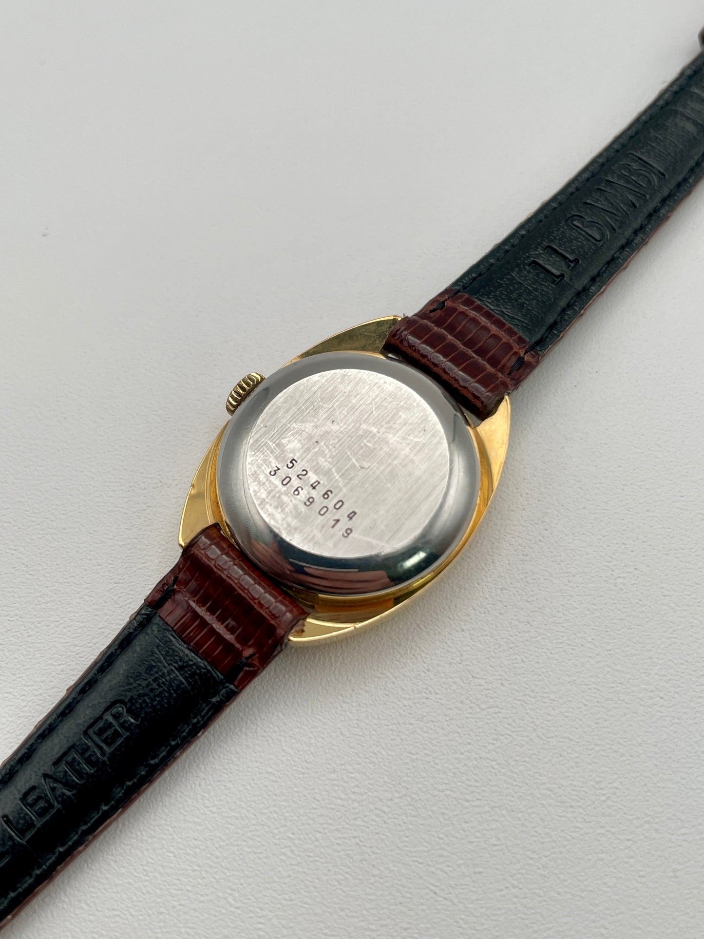 Caseback view showing engraved serial numbers on the Universal Geneve watch