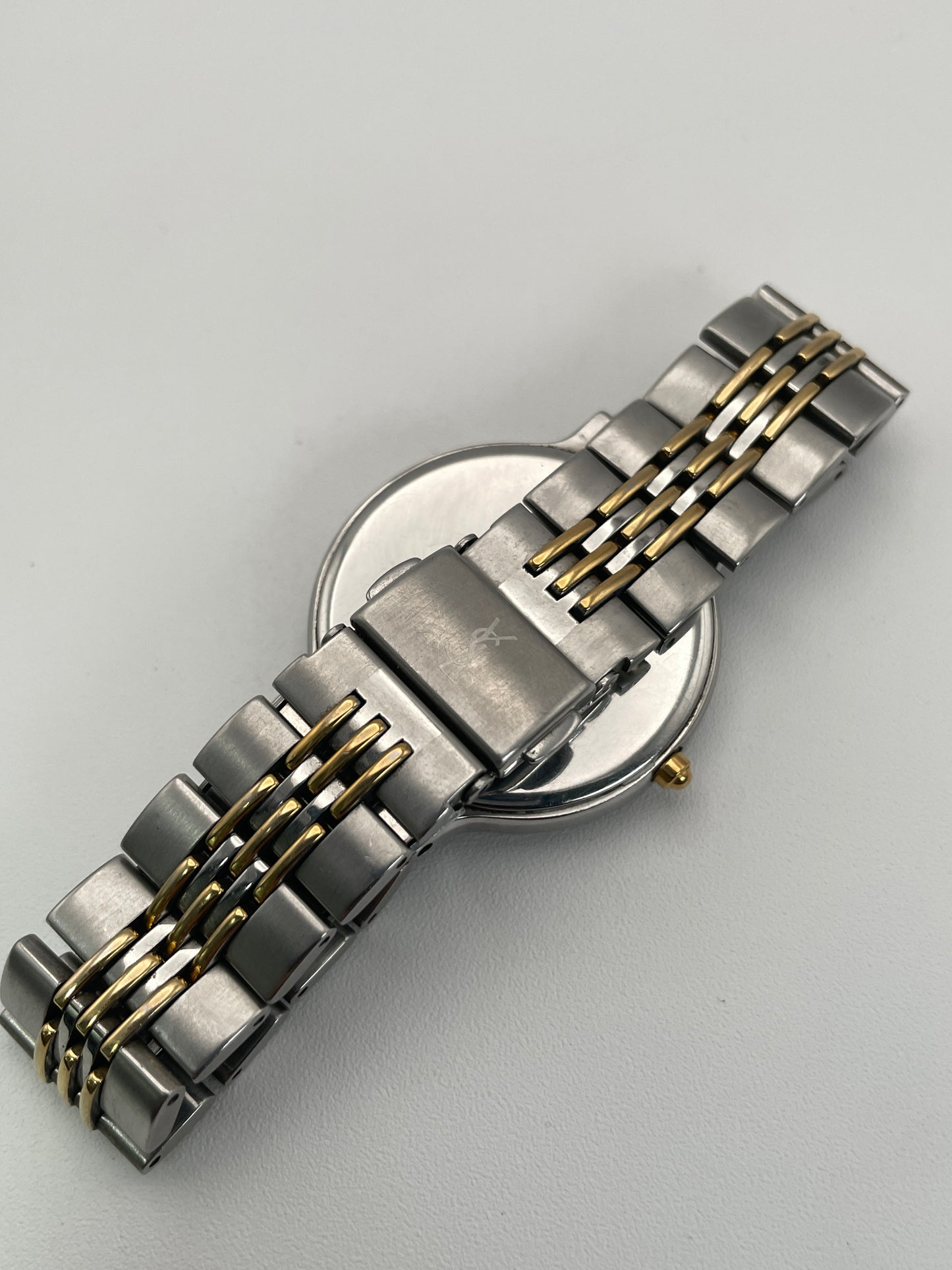 Close-up of the clasp on the YSL La Collection vintage women's watch featuring a stainless steel and gold-tone bracelet.