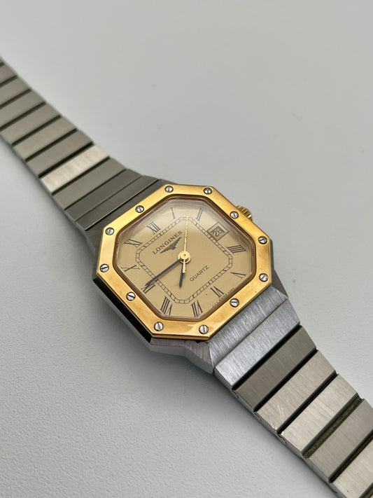  1980s Longines Octagon "Royal Oak" ladies quartz watch with a gold-tone dial, bezel screws, and a stainless steel bracelet.