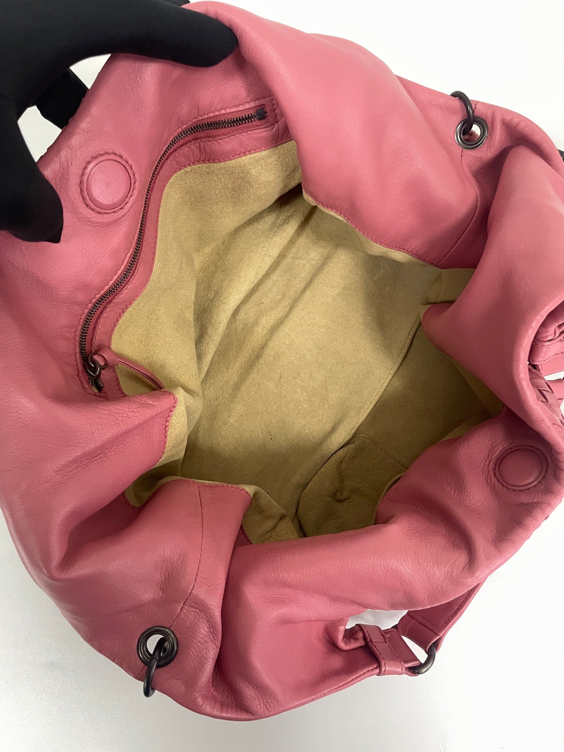 Interior view of the Bottega Veneta Intrecciato Campana Shoulder Bag in pink leather, showing the beige suede lining and internal zipper pocket.