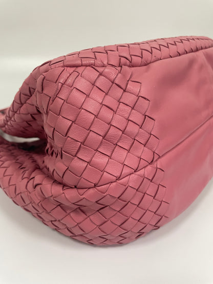 Bottom corner view of the Bottega Veneta Intrecciato Campana Shoulder Bag in pink woven leather, showing the structured leather base and bottom corners.